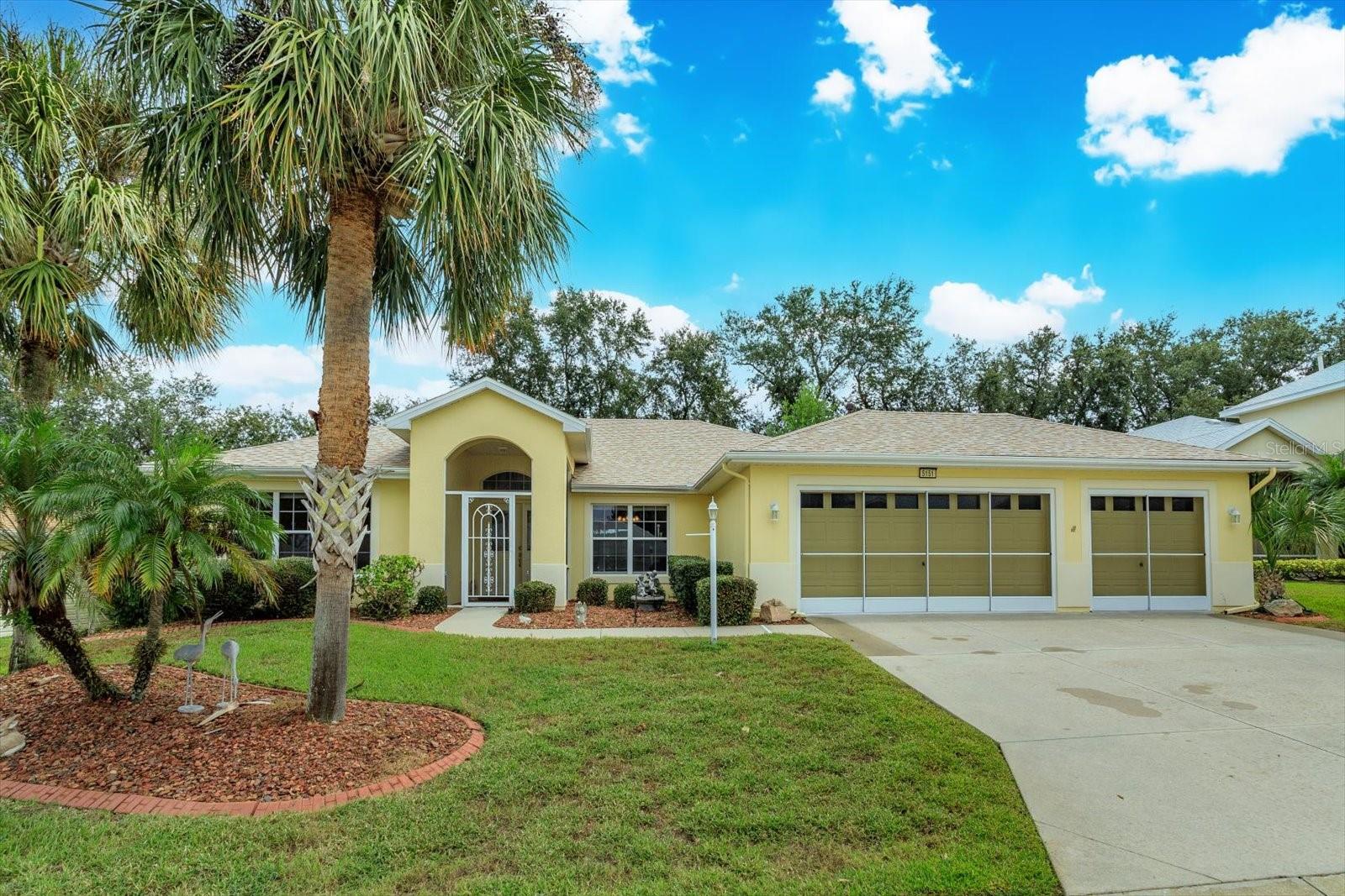 Welcome home to your dream 55+ community in beautiful Lake County! Royal Harbor offers dozens of amenities and there is a club for just about any interest! See the list of community offerings attached to this listing! This home offers four full bedrooms, Two baths, full three car garage, a screen enclosed pool with both covered and open deck Space. The front door is screen enclosed for added weather and bug protection. Upon entering this home you will see open living space with beautiful wood floors and high ceilings. The floorplan offers a three way split with the primary bedroom off to the left back of the home, the fourth bedroom off to the left front and bedrooms two and three on the far right side of the home. The kitchen offers 42" wood cabinets, granite countertops, new stainless steel appliances, a 10' breakfast bar, laundry room access and a 10x9 eating space with pool views. The Primary bedroom is 19x13 and offers a large walk in closet, Electric Wall heater, dual sinks, linen closet, soaking tub, a separate shower and a frosted window for natural light. Community has a fishing pier on Little Lake Harris and offers RV/Boat storage. This home is ready for a new owner, call for your private showing today!