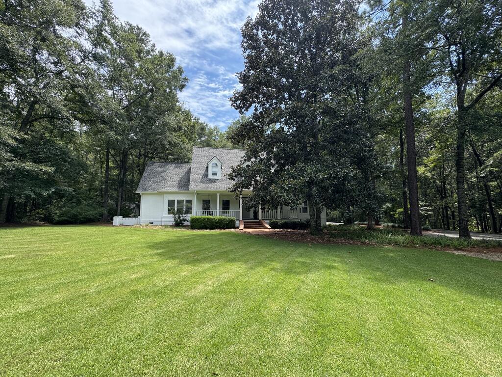 Updated traditional brick home boasts modern European flair, stunning wooded views, and an ideal location only 30 minutes North of Tallahassee and less than 4 minutes from Brookwood School.  This beautifully remodeled 5-bedroom/3.5-bath home (plus a 1/1 detached garage apartment) features a chef's kitchen with full-sized Subzero fridge & freezer, Wolf steam and convection wall ovens, Wolf gas range with griddle, Bosch convection oven/microwave combo, and Cove dishwasher. Pecky cypress beams and painted tongue-and-groove details enhance the space with rich textures, while the oversized quartz waterfall island provides plenty of prep space and additional storage. Two oversized 4x6 windows bring in natural light and capture the beautiful views of the surrounding landscape. The living room, with its soaring vaulted tongue & groove ceiling, is equally impressive offering built-ins, a wet bar, and a cozy ambiance with wood-burning fireplace (gas starter) and walk out wrap-around deck overlooking the private wooded backyard. The master suite offers a separate sitting room or office area, built-in bookshelves/desk, and a beautifully appointed bathroom that boasts a custom-built floating wood vanity, free standing tub for two, oversized walk-in shower w/ rainfall shower head, and closet with custom built-in wood drawers & shelving. Other updates include more modern colors, lighting, fixtures, switches, and fans throughout. The spacious apartment (460 sqft) is finished with real wood plank paneling and includes a fully renovated bathroom and LVP flooring making it ideal as a guest suite, media room, home office, exercise room, or VRBO. Enjoy outdoor living with front and back porches, a stream running at the back of the property, and easy access to the pool and clubhouse just up the street! Additional features and amenities worth noting include a whole house water softening system, reverse osmosis drinking water filtration system, encapsulation w/ dehumidifier, commercial sized tankless water heater, a wired 14X16ft workshop, and climate-controlled storage in the garage featuring wall-mounted bike racks & cabinets. This stunning home truly combines luxury, practicality, and beauty and is sure to be the perfect retreat for its next owners! Sellers are licensed Realtors in the state of GA #369599/#391145.