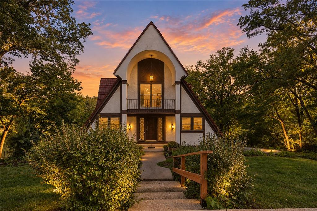 Welcome to the ultimate lakefront lifestyle at 7616 NW Eastside Drive! Weatherby Lake isn’t just a neighborhood; it is a tight-knit community where every day feels like a private vacation. Imagine starting your mornings walking the community trails, meeting friends for a match on the local tennis and pickleball courts, and attending events at the community center. Located within the highly rated Park Hill School District, this property offers the incredibly rare combination of a peaceful waterfront retreat with quick, easy access to shopping, schools, and the airport.Nestled perfectly on the water, this historic A-frame Tudor home features 4 bedrooms, 3.5 bathrooms, and 3,360 square feet of character. Inside, soaring ceilings, warm wood interiors, and a cozy wood-burning fireplace create an inviting lodge-like feel. But the true magic is out back. Step out to a spectacular, private setting with an rare 125+ feet of shoreline on deep, desirable water. Tucked into a quiet cove, this lot offers the ultimate bonus: the neighboring property to the east is a dedicated access area, ensuring you will never have neighbors building right next to you on that side! With boating, swimming, and fishing right in your own backyard, this is a once-in-a-lifetime opportunity to own a piece of authentic lake history.Weatherby Lake Transfer fee for new residents of 3600 and 300 Dock Transfer fee.