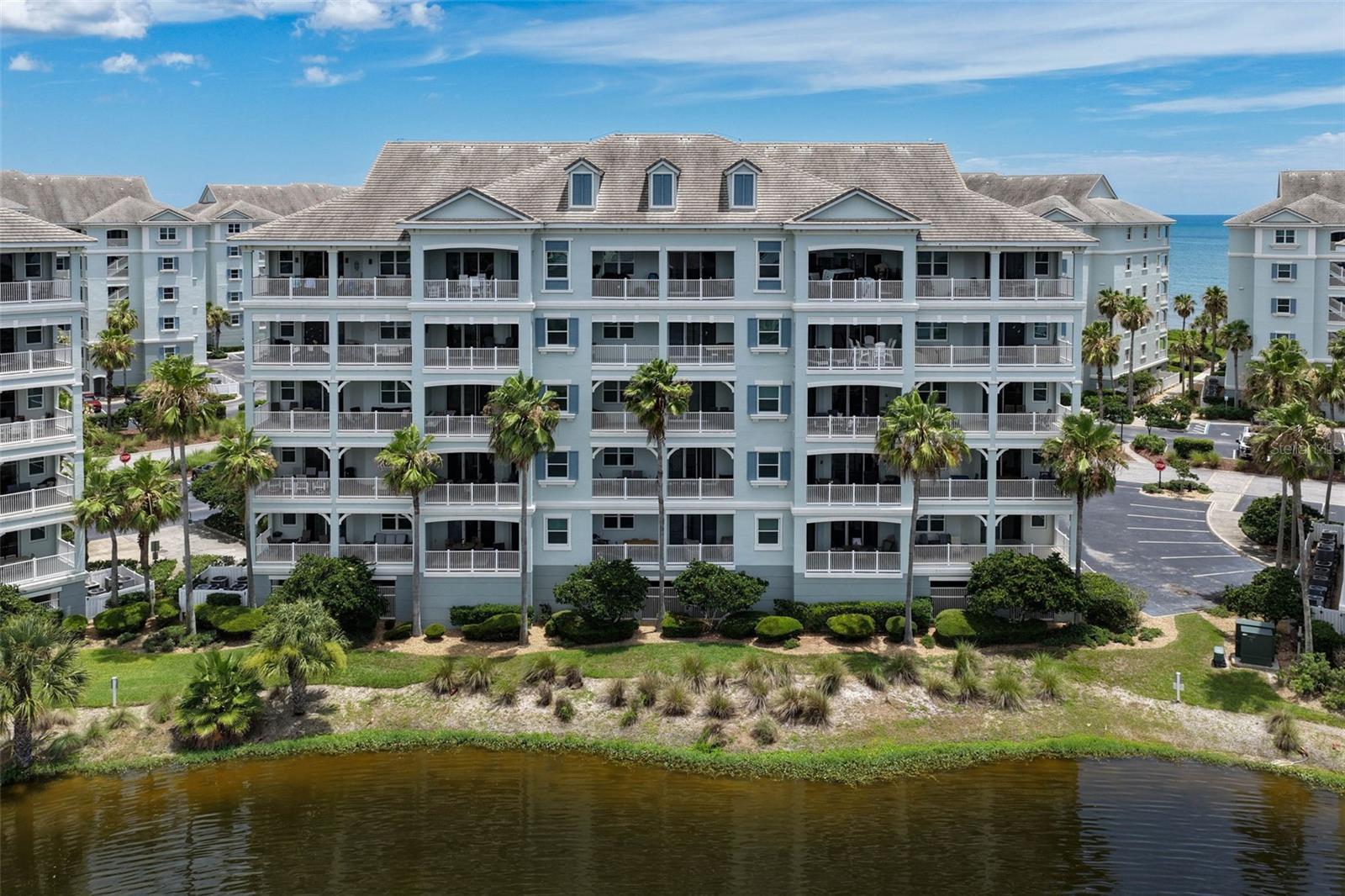 Priced to sell!! Enjoy the best of coastal resort living in this beautifully updated second-floor condominium located within the highly sought-after gated community of Cinnamon Beach at Ocean Hammock. Overlooking a tranquil lake with glimpses of the Atlantic Ocean beyond, this spacious residence offers the perfect blend of comfort, style, and investment potential.The open-concept floor plan features luxury vinyl plank flooring throughout the main living areas, crown molding, and abundant natural light. The renovated kitchen is designed for both functionality and entertaining, showcasing cabinetry, quartz countertops, stainless steel appliances, a large breakfast bar, and a coastal-inspired tile backsplash. The kitchen flows seamlessly into the dining and living areas, creating an inviting space for gathering with family and friends.Sliding glass doors open to a generous covered balcony overlooking the lake, providing the ideal setting to enjoy morning coffee, evening breezes, and picturesque water views. The spacious living room is thoughtfully designed with comfortable seating and coastal finishes, while the dining area offers ample room for entertaining.Located just steps from the beach, this residence provides easy access to Cinnamon Beach's exceptional amenities, including oceanfront and lakeside pools, a fitness center, game room, seasonal café, clubhouse, and private beach access. Whether you're seeking a primary residence, vacation retreat, or income-producing rental property, this turnkey condominium offers an outstanding opportunity to enjoy the Florida coastal lifestyle.Community Features: Gated Oceanfront Community • Beach Access • Oceanfront & Lakeside Pools • Fitness Center • Clubhouse • Seasonal Café • Game Room • Walking Trails • Short-Term Rentals Permitted.