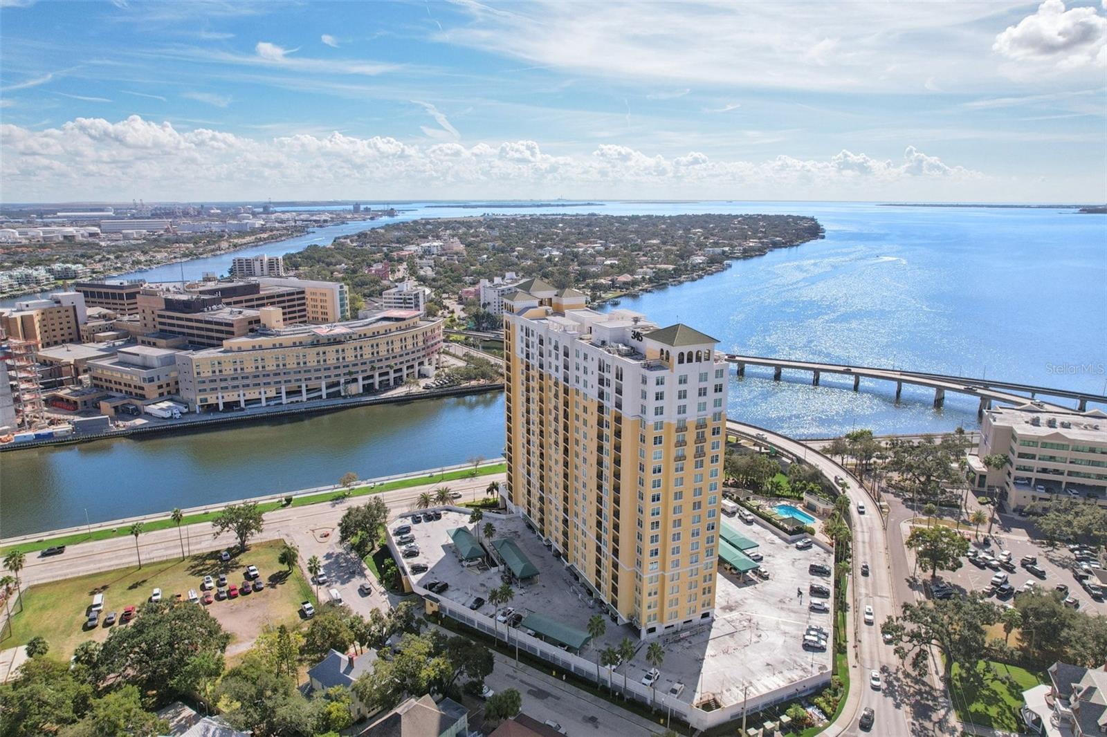 Under contract-accepting backup offers. Sky-High Living on Bayshore—Where Every Room Frames the View! Perched on the Grand Penthouse level of a coveted Bayshore Blvd building—directly across from Tampa General Hospital—this stylish 2-bed, 2-bath condo delivers an exceptional blend of comfort, convenience, and breathtaking scenery. With sweeping views of the downtown skyline and sparkling water vistas from every room, this 1,022-sq-ft retreat feels like a private sanctuary above the city. Wood floors flow through the main living space, adding warmth and continuity, while tile flooring extends through the bedrooms, bathrooms, and kitchen for easy care and durability. Inside, 9-ft ceilings with crown molding set an elegant tone, and updated touches like shiplap and stone accent walls elevate the coastal-modern feel. The kitchen features stainless-steel appliances, and both bathrooms have been thoughtfully updated—including a refreshed second bath showcasing a modern, updated shower. The primary suite offers a generously sized layout and a large walk-in closet for exceptional storage. Step onto the expansive outdoor balcony and enjoy sunrise coffee, evening breezes, or the twinkle of downtown lights as the city comes alive below. The building itself offers a truly impressive lifestyle, with three new elevators being installed and an unmatched lineup of amenities designed for comfort and convenience. Residents enjoy two fitness centers—one dedicated to cardio and the other to weights—along with men’s and women’s saunas for unwinding after a long day. Recently renovated guest suites are available for rent, making hosting visitors effortless. Additional perks include a party room, a dedicated media and office space, a welcoming library, and a heated-and-cooled pool with a BBQ area perfect for year-round enjoyment. Concierge service and secure building access complete the experience, adding both peace of mind and everyday ease. Practical perks include an AC-cooled storage unit (A48), two parking spaces (one covered end space #35 and one uncovered end space #315), plus ample guest parking. With its premier location, stunning views, and a full suite of amenities, this penthouse-level condo offers a lifestyle that’s both effortless and extraordinary—ideal for anyone seeking comfort, convenience, and the best of Bayshore living.