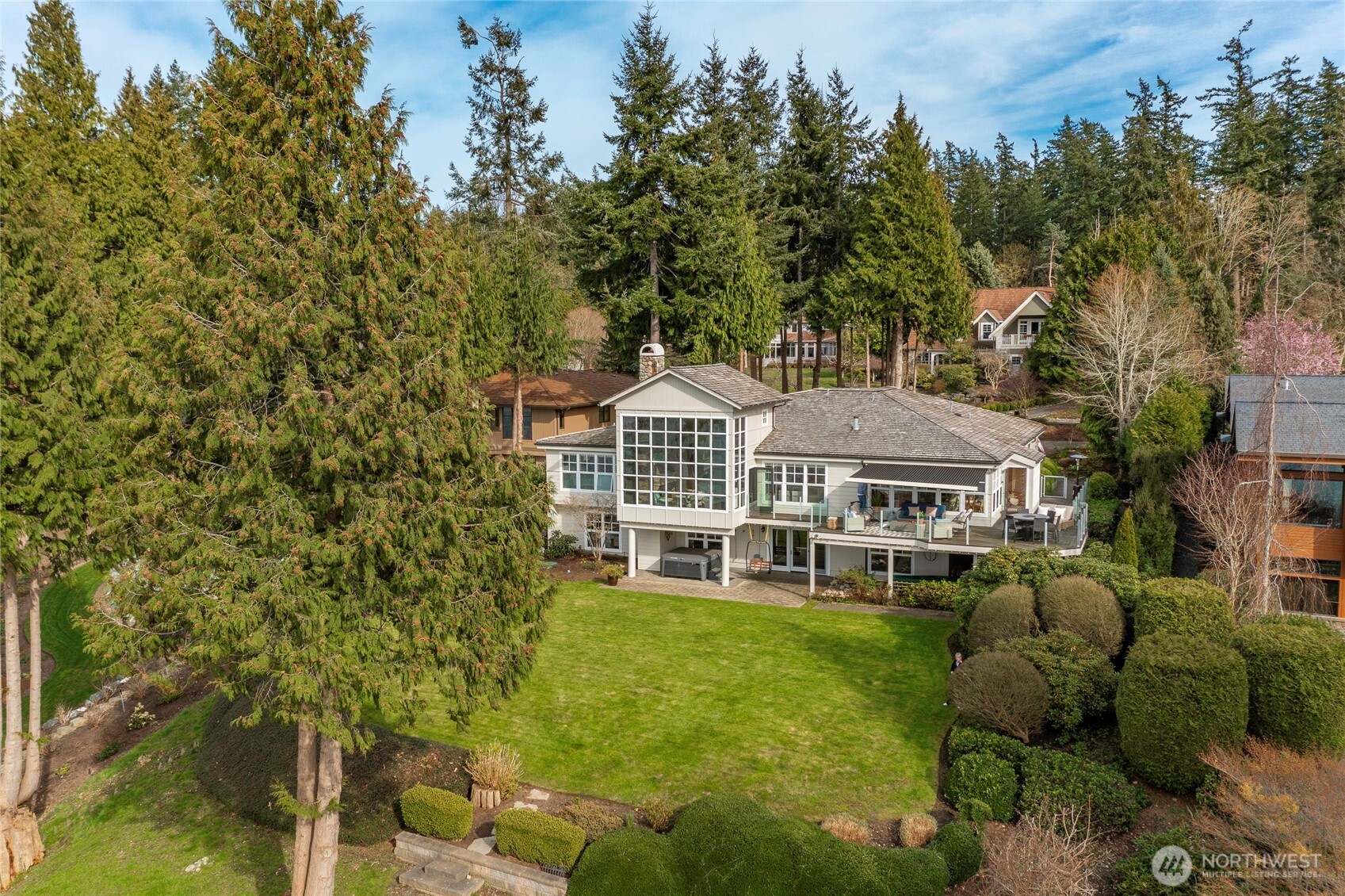 What if this was how every day felt—wide-open water views, boats drifting by, and sunsets that make you stop and take it all in? Set within the highly sought-after Boundary Ridge neighborhood, this is considered one of the very best waterfront locations in all of Semiahmoo.    The setting is what makes this home so special. A shy acre of level, beautifully maintained grounds—rare for waterfront—offers room to gather, garden, play, or simply enjoy the peace and privacy. It feels tucked away, yet just moments from everything Semiahmoo offers, including golf, marina, spa, pickleball, and endless outdoor activities.    Inside, walls of windows fill the home with natural light and keep the water in view from nearly every room. The layout is comfortable and easy, with main-level living that includes a spacious primary suite and multiple areas to relax or entertain.    At the center is the kitchen, opening to casual dining and an inviting living space, while a built-in corner office makes working from home easy. On the lower level, large private guest suites offer a welcoming retreat for visitors.    Step outside and it all comes together—an expansive deck and patio designed for long summer evenings, quiet mornings, and year-round sunsets over the bay, with views stretching to the Canadian coastal mountains and three ski areas glowing at night.    Homes like this are rare—unobstructed views, a level yard, and one of Semiahmoo’s most exceptional waterfront settings.