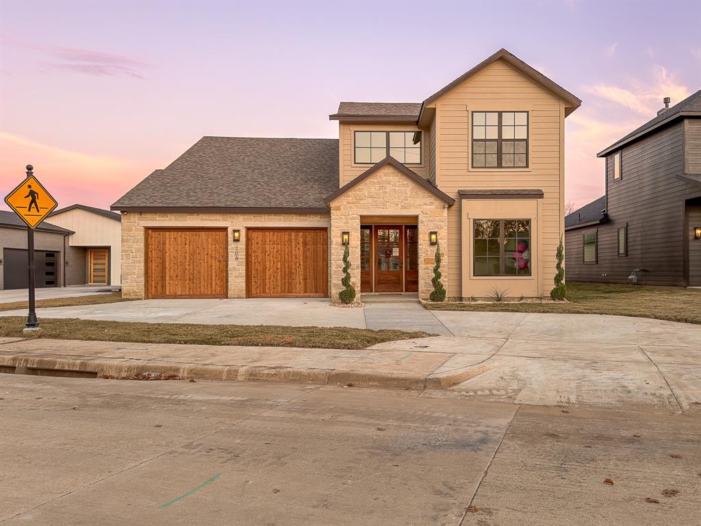 Rare is the word. A brand new custom by Lily Grace Homes set on a private 0.69-acre lot in the heart of Old Town Roanoke, steps from Oak Street's Unique Dining District and Byron Nelson Boulevard. This 3,474 sq ft, 4-bedroom, 4 full-bath, study residence pairs walkable downtown living with a backyard most Roanoke buyers only dream of. Room for a pool, pickleball, or a future casita. Inside, 10-foot ceilings soar to 11 feet in the family room, where an 11-foot sliding glass wall opens to an oversized covered patio already plumbed and wired for your outdoor kitchen. Wide plank 7.5-inch European white oak floors flow through the main level and into a chef's kitchen anchored by an oversized island in Taj Mahal quartzite, custom site-finished stained white oak cabinetry, and a full ENERGY STAR Bosch appliance suite including a 36-inch gas cooktop, 30-inch double wall oven, and 36-inch counter-depth French door refrigerator. The walk-in prep pantry adds its own sink and shelving. The owner's retreat features a freestanding soaker tub, matte-black Delta fixtures, a walk-in shower with a recessed niche, and designer tile in a spa-quality palette. Cool all summer without the sweat of a high electric bill. This home carries a HERS Index of 52, roughly 48 percent more efficient than a standard new build, with a projected average energy cost near $197 per month. Dual-zone ENERGY STAR Friedrich inverter heat pump (18 SEER2 down, 16.5 SEER2 up) pairs with full spray foam encapsulation, a ZIP wall air barrier tested at a tight 3 ACH50, Low-E insulated windows, a Navien condensing tankless water heater, and an Ecobee smart thermostat. James Hardie siding, stone masonry, mahogany front door, LiftMaster Wi Fi garage openers. 10-year structural warranty. Northwest ISD. Move-in ready.