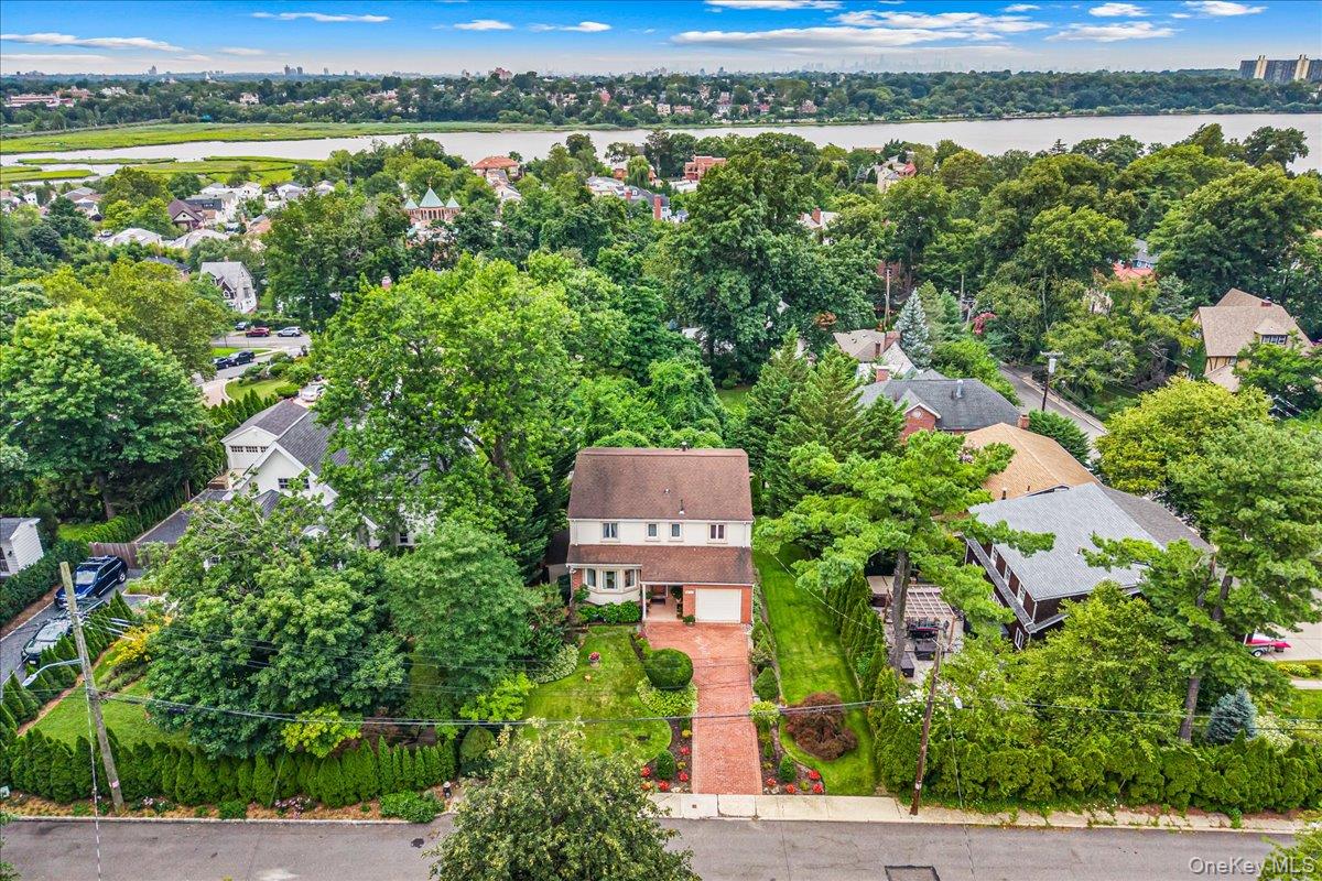 A meticulously maintained home  in the coveted Douglaston, NY neighborhood. Only one block from the historic Douglas Manor. During the winter months enjoy views of Manhattan and Little Neck bay from the two upstairs bedrooms providing a potential upgrade opportunity.Experience the perfect blend of suburban tranquility and New York City convenience in this 5-bedroom, 3 full bath, and 1 half bath home, ideally situated in this highly sought-after neighborhood. Designed with flexibility in mind, this exceptional residence is thoughtfully configured for multi-generational living, offering an ideal layout for extended family, guests, or private living arrangements while maintaining comfort and privacy. Spacious living areas, generous bedrooms, and thoughtful updates make this home perfect for both everyday living and entertaining. Located in the award-winning NYC School District 26, this home is just a short walk to the Long Island Rail Road, shopping, restaurants, houses of worship, parks, and schools, providing unmatched convenience while preserving the charm of a suburban lifestyle. Enjoy proximity to the prestigious Douglaston Club and the Douglaston Golf Course, along with access to Little Neck Bay for boating, kayaking, paddle boarding, or simply enjoying the waterfront lifestyle. Whether you're looking for top-rated schools, a home designed for multi-generational living, or an unbeatable location, this property presents a rare opportunity to own one of Douglaston's finest homes.