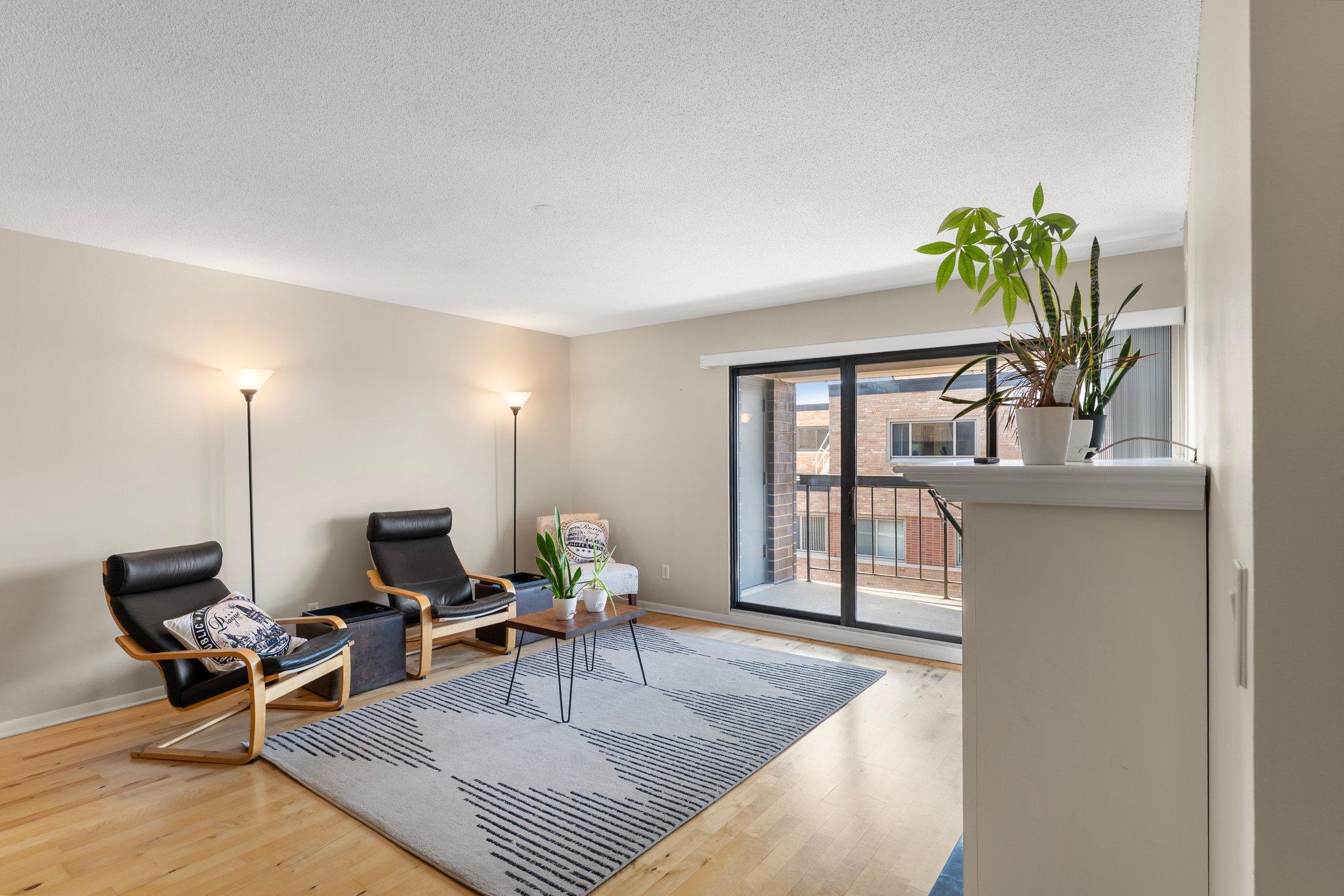 Welcome to this beautifully designed 1-bedroom, 1-bathroom condo in a sought-after Minneapolis high-rise—offering style, comfort, and unbeatable access to some of the city’s most beloved outdoor spaces. Just a short walk from both Lake of the Isles and Bde Maka Ska, this location offers the best of urban living with a serene lakeside atmosphere. Surrounded by scenic trails, parks, and beaches, you’re also just minutes from vibrant shopping districts, diverse dining options, and popular entertainment venues.
Inside, you’ll find an inviting open-concept layout filled with natural light and stylish finishes throughout. Maple wood flooring runs across the main living areas, creating a cohesive and warm aesthetic. The entryway includes a large hallway closet for coats, shoes, and everyday storage.
The modern kitchen is as functional as it is beautiful—featuring sleek stainless steel appliances, contemporary lighting, and generous cabinetry. Under-cabinet lighting highlights the clean lines of the counters and enhances the atmosphere for both casual meals and culinary creativity.
A dedicated dining area provides a comfortable space for daily meals or hosting guests, with seamless flow into the spacious living room. Here, a stunning electric fireplace with elegant marble detailing adds both ambiance and a focal point. Large sliding glass doors allow abundant sunlight to stream in and lead to a private 13x5 balcony—perfect for morning coffee or evening relaxation. From this elevated vantage point, enjoy seasonal views of Bde Maka Ska and peaceful treetop surroundings. A 5x4 storage closet on the balcony adds even more space for keeping things organized and tucked away.
The tranquil bedroom is generously sized and bathed in natural light from its own sliding glass doors, which also open onto the balcony—allowing you to step directly into the fresh air. Plush carpeting underfoot and a ceiling fan overhead create a cozy, restful retreat. Two floor-to-ceiling closets provide excellent storage and keep the space tidy and functional.
Located just off the main living area, the updated full bathroom offers tile flooring, a sleek vanity, and a tub/shower combination with stylish tile surround. A second hallway closet nearby offers additional storage space for linens or cleaning supplies.
An in-unit laundry area adds everyday convenience with a designated 5x5 space featuring built-in shelving, cabinetry, wood flooring, and a practical hanging rod—offering organization and efficiency.
Included with the unit is a designated parking spot in the building’s secure, heated underground garage. The space also includes built-in cabinetry for additional storage—perfect for tools, seasonal items, or hobby gear. Residents also enjoy the added bonus of an on-site car wash bay for year-round vehicle care.
The building’s top-floor amenities offer incredible value, including a beautifully appointed community party room with a full kitchen—ideal for hosting gatherings or private events. Step outside to the expansive rooftop deck and take in breathtaking 360-degree views of the Minneapolis skyline, nearby lakes, and glowing sunsets. (Completion of the fully funded rooftop deck is anticipated in 2026). Don’t miss out on this thoughtfully designed condo that delivers both lifestyle and location.