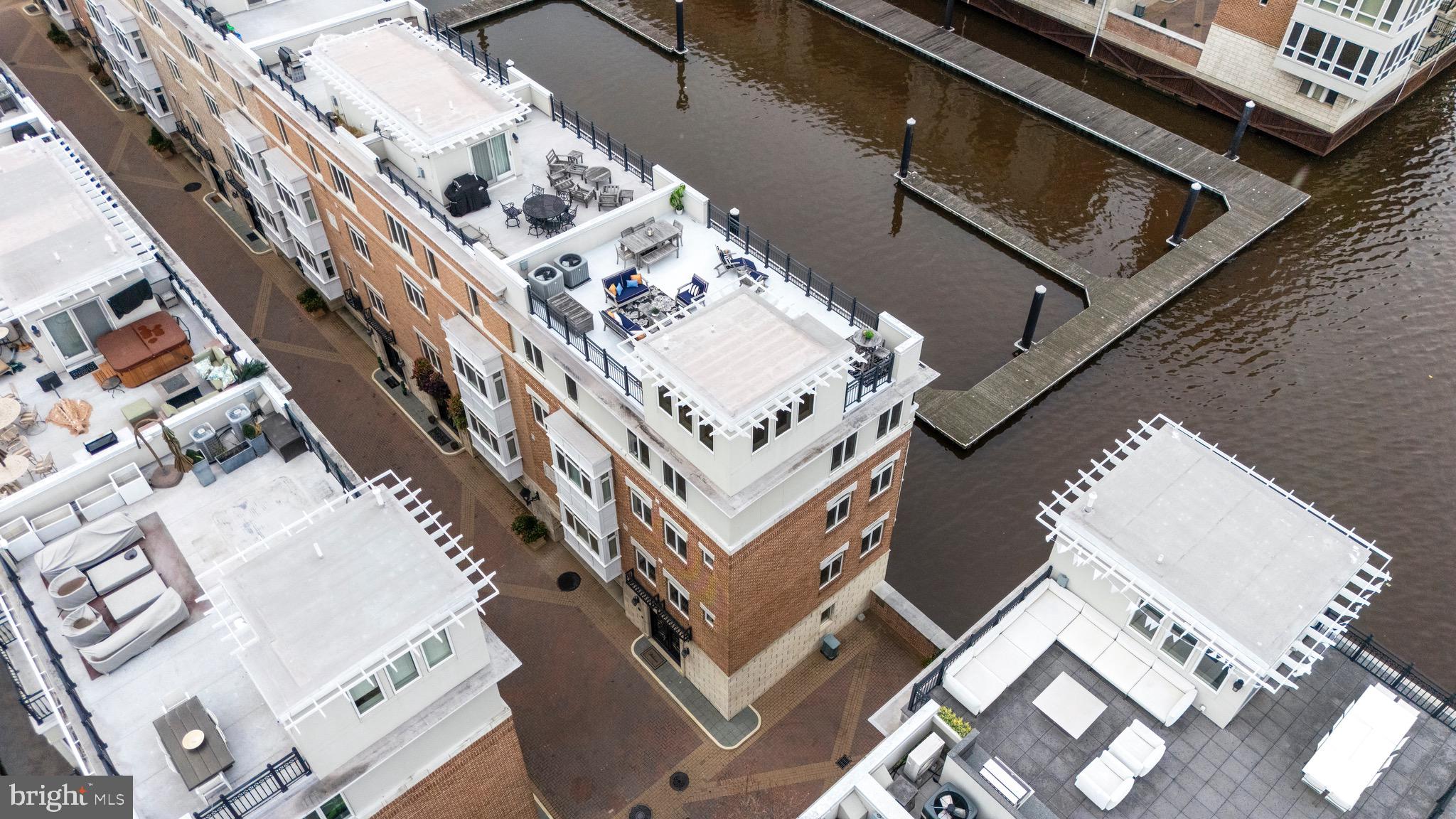 A truly exceptional opportunity to own one of Baltimore’s most unique and coveted residences at the Pier Homes at Harborview. Ponte Villas S offers exceptional proximity to Washington DC and Baltimore’s central business district. Minutes from I95, the nations capital and key DC locations are within 35-40 miles by car and easily accessible via the MARC Camden line in 30-45 minutes. The new corporate campuses of T. Rowe Price and Under Armour are minutes away via water taxi, a short walk or drive. Residents enjoy the best of both worlds — serene waterfront living with effortless access to the nation’s capital. This striking four-level townhome at 650 Ponte Villas South offers an extraordinary living experience with panoramic, stunning views of the Inner Harbor from nearly every room. The seamless connection between elegant interior spaces and the tranquil waterfront setting creates an atmosphere of sophistication, privacy, and serenity rarely found in city living. Enter through a private, secure entrance into the main level, where you will find a private guest suite complete with an en-suite bathroom and convenient elevator access to every floor — ensuring comfort and accessibility throughout the home — and a two-car garage. The next level features an open-concept living space boasting high ceilings, rich hardwood floors, and expansive windows framing the harbor’s waters. The gourmet kitchen features premium stainless-steel appliances, granite countertops, custom cabinetry, and a large breakfast bar — perfect for entertaining. The adjoining dining and living areas — separated only by an elegant double-sided gas fireplace — flow effortlessly toward a private waterfront terrace, ideal for an evening of relaxation while watching boats glide across the harbor. The entire third level hosts a beautifully appointed primary suite offering a sitting area, an additional double-sided gas fireplace, a private terrace, and floor-to-ceiling windows that capture breathtaking sunrise views over the marina. The spa-inspired en-suite bath includes dual vanities, a soaking tub, and a large, separate glass-enclosed shower. A spacious walk-in closet complements the suite’s refined design. The fourth level features an additional flexible social space and outdoor terrace, perfect for entertaining or relaxing, as well as two spacious bedrooms offering generous storage and a well-appointed family bathroom. Take the stairs or private elevator to the spectacular rooftop terrace with wet bar, boasting nearly 1,000 square feet of outdoor living space with jaw-dropping panoramic views — ideal for sunset gatherings or starlit evenings. Residents of the Pier Homes at Harborview enjoy exclusive access to a private, resort-style Health Club featuring a state-of-the-art fitness center, heated indoor pool, whirlpool spa, and sauna — all designed to promote wellness and relaxation. Beautifully maintained waterfront promenades, landscaped courtyards, and a marina setting enhance the community’s tranquil, upscale atmosphere. With 24-hour security and concierge service, residents experience a perfect balance of luxury, comfort, and peace of mind. Living at the Pier Homes at Harborview offers more than a home — it’s a refined lifestyle defined by health, privacy, and spectacular harborfront living. Baltimore’s Inner Harbor is set for an exciting transformation with the $900 million Harborplace redevelopment, breaking ground in fall 2026. The project will replace the aging pavilions with four new mixed-use buildings featuring retail, dining, residential, and vibrant public spaces, creating a revitalized waterfront that enhances walkability, commerce, and livability. This  will further solidify the Inner Harbor as the city’s premier cultural and social hub.