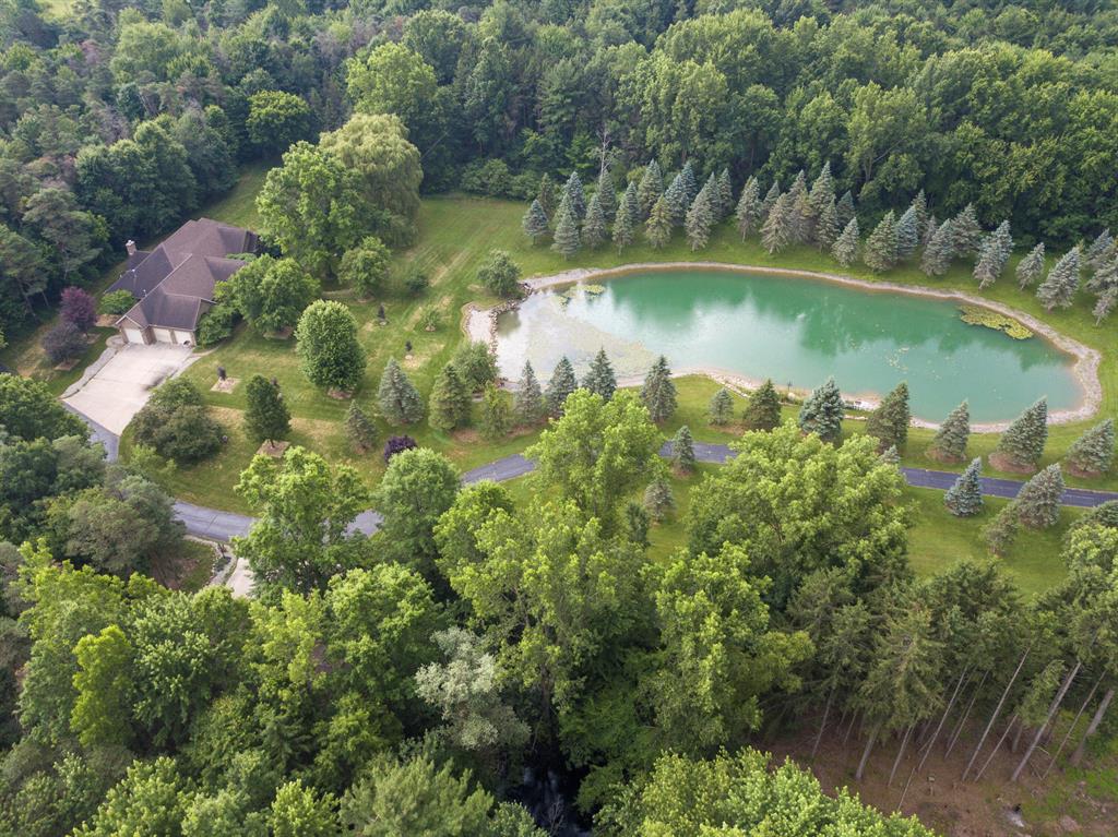 Immaculate home and pond on 63 ac in Saginaw County! No expense was spared in the build of this 5 bed 4 bath brick home. The upstairs features two separate living areas, formal dining, fireplace and half kitchen in the hall to the master bedroom.  Additionally, there is a West wing with a full kitchen, bath, living room and bedroom.  The full basement is unbelievable, with a massive gathering and living area, full kitchen, custom bar space, bedroom with full bath and a 10 person sauna!  Outside you will find the 30x60 garage for toy and equipment storage.  The land is a combination of open ground with fruit trees and spruce trees randomly scattered and thick woods that is loaded with deer and turkeys.  This is truly one you need to see in person to appreciate!  Contact the listing agent directly for more information.  Showings are TBD starting sometime at the end of October.