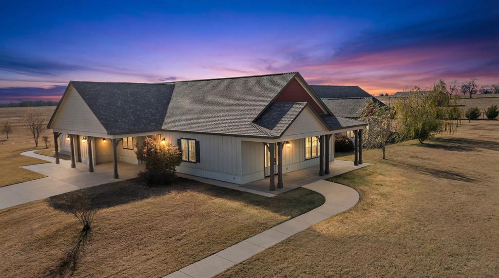 A landscaped entry & security gate enhances this 6 bedroom 6 bath Custom Home designed & built for a large family or flexible living & entertaining! Modern touches include 10' ceilings, crown molding, recessed LED lighting, custom roll up shades, quartz countertops, ex-large bedrooms, double vanities in baths, tiled walk in showers & more! With 2 separate wings, this unique design centers around 2 full-size kitchen areas plus a massive dining  & entertaining area. Windows provide plenty of natural light. A wood stove with circulating fan keeps you warm & cozy. The kitchens feature quartz countertops, island, gas stoves, double ovens, 2 refrigerators, double pantries, buffet kitchenette & more. The master bedroom comes with his & her baths, double closets, overhead storage system, a coffee bar, sink & private porch. The 5 large bedrooms all have custom closet system with additional overhead storage. The baths have double vanities, 2 with tubs & 2 with tiled showers. Plenty of space & storage in all baths. Both utility rooms come with washer-dryer hookups & plenty of room for freezers & refrigerators, plus one room comes with a sink & quartz folding table. A landscaped yard provides curb appeal with a variety of bushes, shrubs, trees, & custom irrigation system. Stay safe with a large capacity concrete storm shelter. An extended concrete patio & concrete basketball court accentuates the backyard, ready to enjoy. The 75x75 metal shop includes foam insulation, concrete, electric, water, 6 roll up doors, storage room, generator hook up, overhead storage, half bath & covered parking. A 50' metal equipment shed for covered parking. This area is surrounded by graveled parking for large equipment, RV or trailers. Livestock ready, this property has several pastures (Bermuda & Rye grass) with good fencing, water, a 50x50 metal barn, a 25x75 metal barn. One pond provides surface water in front pasture. Additional acreage available. All with easy access to Sherman, Paris or DFW!