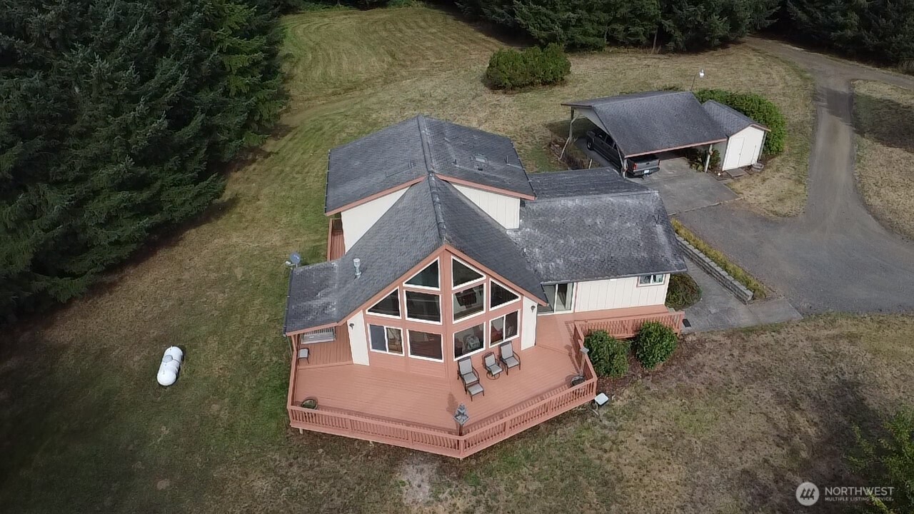 Very private and clean home with incredible mountain and territorial views! This 3 bed, 2 bath, 1 ½ story features vaulted ceilings, open floor plan, and a loft-style primary suite with sweeping views. Enjoy the large deck, covered back porch, and 2-car carport. Property includes a shop, storage shed, pasture, 30-year-old fir trees, and is partially fenced. Heat pump for year-round comfort. Two parcels included—perfect blend of comfort, space, and nature!