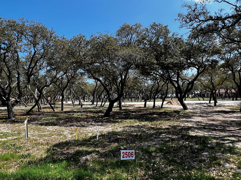 See what is behind the gate at Royal Oaks! The name says it all with majestic oak trees blanketing each lot. Only limited to one's imagination, this 4534 sq.ft. lot is ready for your custom build to commence. This exclusive gated waterfront community provides the pleasure of privacy with the storybook elegantly curved walls that line the front and back of the community. Entering the neighborhood over the cobble stone road from Fulton Beach Rd, past the guardhouse, immediately a rush of calm takes over. This therapeutic setting will be your place of peace and easy living. Take a minute to stroll the lighted walk paths to the gorgeous pool or gather under the gazebo. Invite friends for an evening around the fire pit to talk about the day on the boat while sipping on your favorite beverage. Need a little putting practice? Pick from the two greens overlooking the bay. Morning, afternoon or evening, the lighted fishing pier is the perfect place to drop a line.