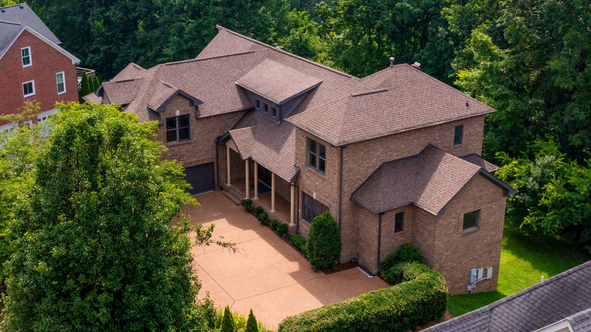 Nestled in the prestigious West Meade neighborhood of Nashville’s 37205, this expansive 6-bedroom, 5-bathroom estate offers unparalleled space, elegance, and versatility. Gleaming sand-and-finish hardwood floors grace the main and upper levels, complementing the soaring ceilings and cozy gas fireplace in the grand great room. The spacious kitchen is a chef’s dream, featuring a large center island with a gas cooktop, custom built-ins, ample cabinetry, Silestone quartz countertops, and a walk-in pantry with a convenient dumbwaiter to the lower-level storage. The main-level primary suite, featuring a tray ceiling, offers a serene retreat, while a guest suite includes a spacious roll-in shower for accessibility. Upstairs, find three well-appointed bedrooms, a versatile loft area, and a large bonus room with a charming beadboard ceiling, perfect for recreation or relaxation. The walk-out lower level provides flexible spaces for an additional bedroom, a wine cellar, or a media room, plus two expansive storage rooms. Enjoy endless comfort with an instant hot water heater and recirculating pump. With stunning views and abundant storage, this sophisticated West Meade residence is ready to become your forever home. Schedule a showing today!