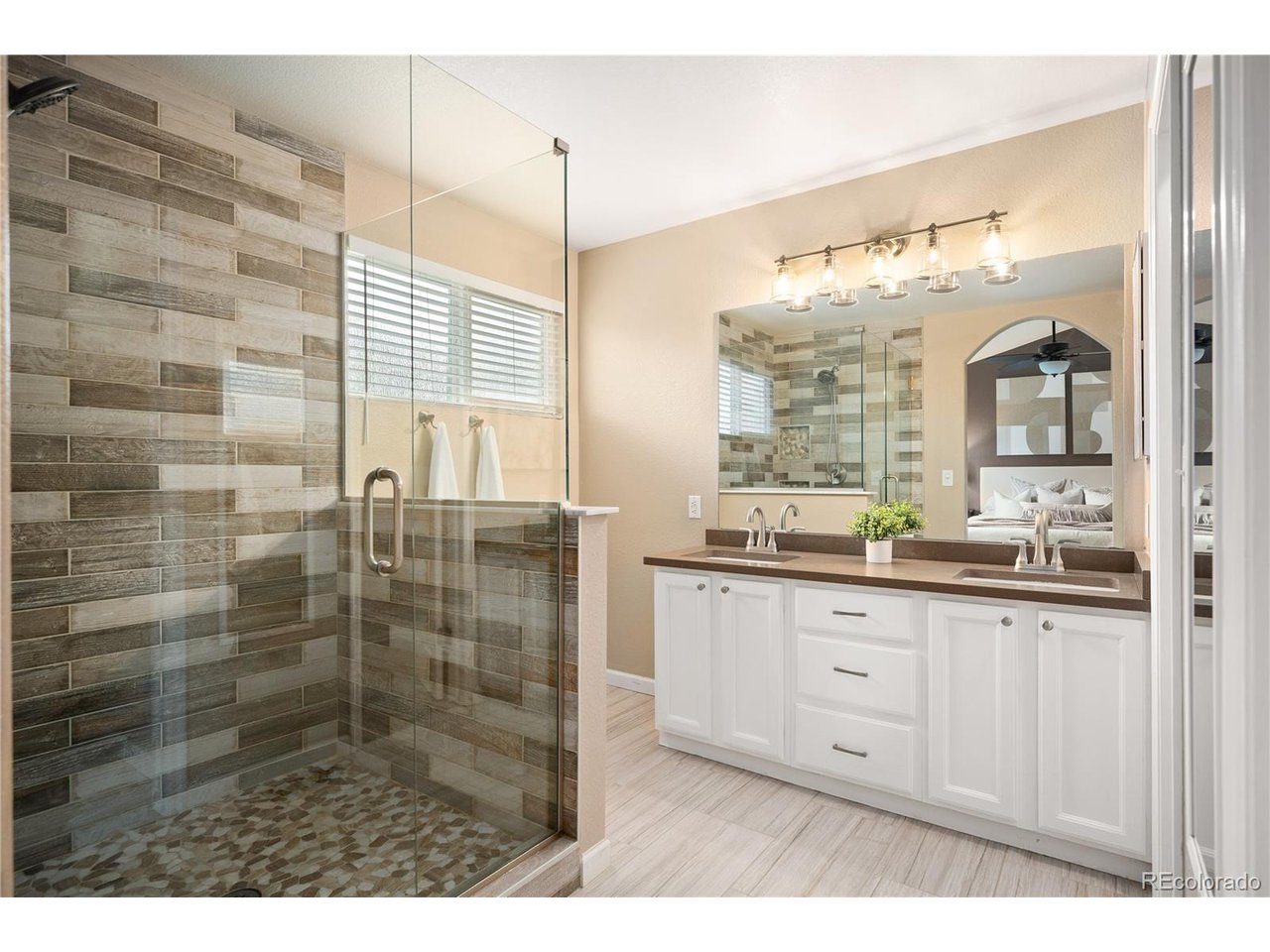 Fall in love with this charming ranch in the highly sought-after Waterford Place neighborhood. Warm, welcoming and wonderfully maintained, this light-filled home offers an easy, comfortable floor plan with thoughtful updates throughout. The heart of the home is the inviting kitchen, featuring updated cabinetry, stone countertops, a playful pop of color in the backsplash and stainless-steel appliances. The spacious living room feels bright and airy with high ceilings and an abundance of natural light, while the adjoining eating area offers flexibility for gathering around the table or enjoying a casual meal at the breakfast bar. The main level primary bedroom is filled with natural light and features vaulted ceilings and a brand-new closet organization system. The beautifully updated primary bathroom adds a fresh, modern touch with a walk-in shower, double vanity and freshly painted cabinetry. A generous guest bedroom and updated guest bath provide a comfortable space, while the office offers flexibility as a potential third bedroom. The laundry room is conveniently located near the attached two-car garage. Downstairs, the finished basement gives you even more room to spread out, with space for a media or family room, an additional bedroom area and a fun, updated 3/4 bathroom. There's plenty of room to make this space your own-movie nights, guests, hobbies or whatever life calls for next. Outside, the large fenced backyard is made for Colorado evenings, with a deck and picturesque pergola creating the perfect setting for al fresco dining and entertaining. And then there's the location. Tucked onto a peaceful block in Waterford Place, you're just minutes from Target, World Market, Chick-fil-A, Black Rock Coffee, the Thornton Recreation Center and beautiful Eastlake Open Space, with easy access to I-25. A little more space. A little more sunshine. A lot of heart. Come see why this just might be your "Home Sweet Home."