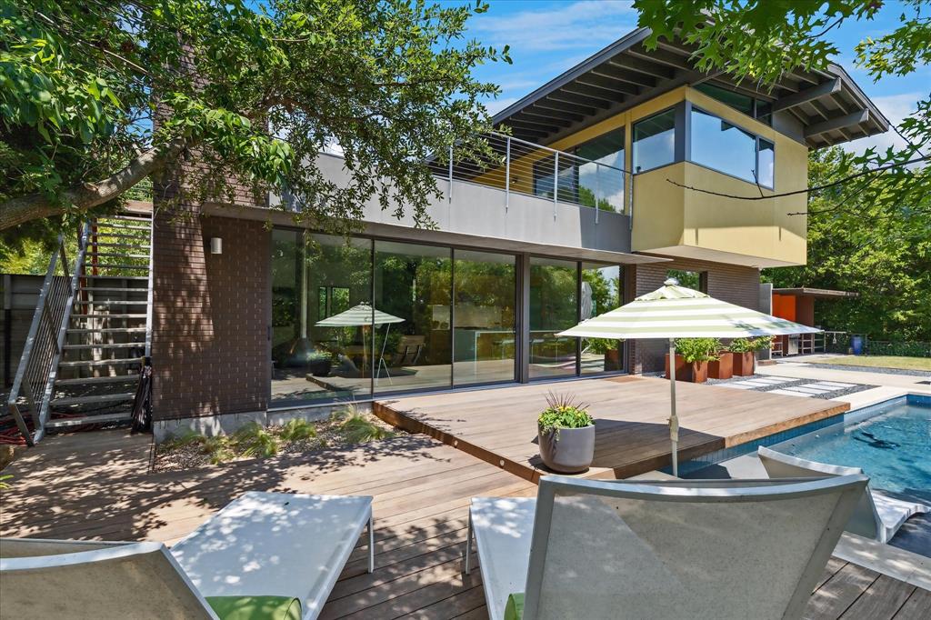 Looking for the opportunity to own an architecturally significant modern home designed by one of the top architects in the city?  It just does not get better than this custom designed home designed by award-winning architect Cliff Welch, FAIA.  Perfectly sited on a wooded 0.76-acre site at the end of a cul-de-sac, the house rises from the expansive front lawn as you approach via a long gravel drive.  Your arrival gives you the feeling that you have traveled to a peaceful secret place.  This is certainly one of the coolest houses in our area.  The house has an impressive design pedigree and has been featured on the White Rock Home Tour twice.  The use of materials including stone and brick fit perfectly and give it a commanding presence sitting at one of the highest elevations in East Dallas.  Inside the house exudes quiet elegance where you will find walls of windows that flood the spaces with natural light and afford views of the infinity pool and wooded site.  Cliff Welch's signature floating walls & warm white oak cabinetry are perfectly complimented by the sleek terrazzo floors. All of the spaces inside and out are nicely proportioned and invite seamless indoor-outdoor living.  The upper level outdoor living room with its Ipe decking affords panoramic tree top views and the downtown skyline in winter.  Don't miss the rare opportunity to own such an architecturally significant home that so perfectly embraces Mid-century Modern style in a timeless modern way.