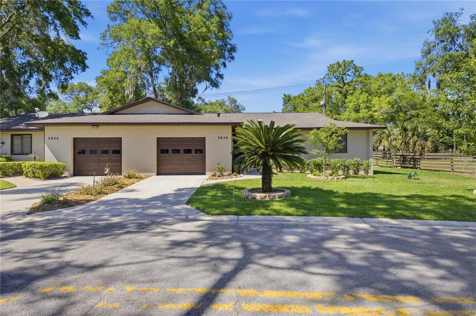 Welcome to this beautifully renovated 3-bedroom, 2-bath home in the highly desirable Village North community of Ocala. This move-in-ready property offers the perfect combination of comfort, style, and low-maintenance living, making it ideal for homeowners and investors alike. Step inside and you’re greeted by soaring high ceilings and a bright, open floor plan filled with natural light. The home features brand-new laminate flooring throughout and a split-bedroom layout that provides both functionality and privacy. The spacious living area is warm and inviting, highlighted by a charming wood-burning fireplace that serves as a cozy focal point for gatherings. The kitchen has been tastefully updated with stainless steel appliances and offers a clean, modern feel with plenty of space to cook and entertain. Both bathrooms have been renovated, giving the home a fresh, updated look from top to bottom. The primary suite is generously sized, complete with a large walk-in closet and plenty of room to unwind. Enjoy Florida living year-round in the enclosed patio, partially under roof and partially screened, creating a versatile indoor-outdoor space perfect for relaxing or entertaining. The backyard features mature landscaping and a peaceful setting to enjoy your mornings or evenings. Major updates include a newer roof (2022) and A/C (2019), along with fresh interior and exterior paint, giving you peace of mind for years to come. The home also includes a 1-car garage for added convenience. The Village North community offers exceptional value with a low $150/month HOA that includes water usage and access to a community pool, lounge area, and entertainment cabana—perfect for enjoying Ocala’s beautiful weather without the hassle of maintenance. Location is everything, and this home delivers. Just minutes from Downtown Ocala, you’ll have easy access to a wide variety of shopping, dining, medical facilities, and everyday conveniences. You’re also close to popular destinations like Silver Springs State Park, known for its crystal-clear springs and outdoor activities, as well as quick access to major roadways for an easy commute. This vacant, move in ready home is ready for its next owner. Homes in Village North rarely come available, making this a unique opportunity you don’t want to miss. Schedule your private showing today.