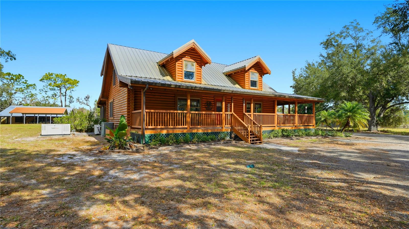 Three-bedroom, three-bath Heritage log home with 8" slow growth eastern pine logs on just under 5 acres.  Featuring a resort-style saltwater pool with waterfall, underwater lighting, in-pool seating, and propane fire pit, all overlooking a spacious 20’ x 40’ covered lanai. High ceilings, private office, and expansive wraparound porch enhance the home’s charm and functionality.Set on 4.5 fully fenced acres with automatic ornamental driveway gate, the property includes a 4-car detached garage, barn from 1952, carport, stocked pond, and a 25 kW whole-home generator with a 500-gallon buried, owned propane tank. Zoned for horses and livestock, with 3-rail wood fencing and wire fencing ideal for pets.Enjoy peaceful country living in Sarasota with convenient access—approximately 15 minutes to I-75, 25 miles to Siesta Key Beach, 22.5 miles to Lido Beach, 22 miles to St. Armands Circle, 13.5 miles to Waterside Lakewood Ranch, and 17.5 miles to UTC Mall.