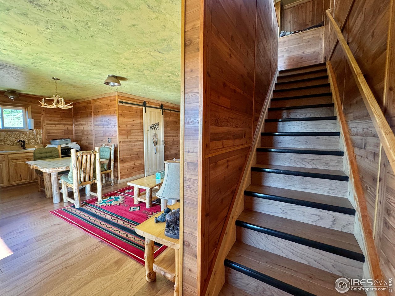 Sitting at the base of Bull Mountain is the ideal hunting retreat! Whether you are a hunter or love photographing wild life, this is the location.  Enjoy the views from the covered east facing porch. Main open floorplan with living room, kitchen, bath and mud room. Two bedrooms on the second floor. Cabin comes fully furnished with Aspen log furniture, barn style doors with rustic hardware throughout and wood burning stove. Hickory cabinets in kitchen. Easy to maintain with laminate flooring and paneled walls and metal roof.  Plus there is an immaculate 24' x 36' insulated shop. Solar system for electric runs lights, refrigerator, etc. 4 panel solar array, 12 batteries, electric/propane refrigerator. Propane range/oven is brand new, never used. Bath has shower, sink and composting toilet. There is a gray water tank that has never been used. Plumbing inside the cabin is all that is left to complete; cistern, sinks, heat-on-demand water heater.  Generator used to pump water from well to fill cistern. There are cameras on the property.