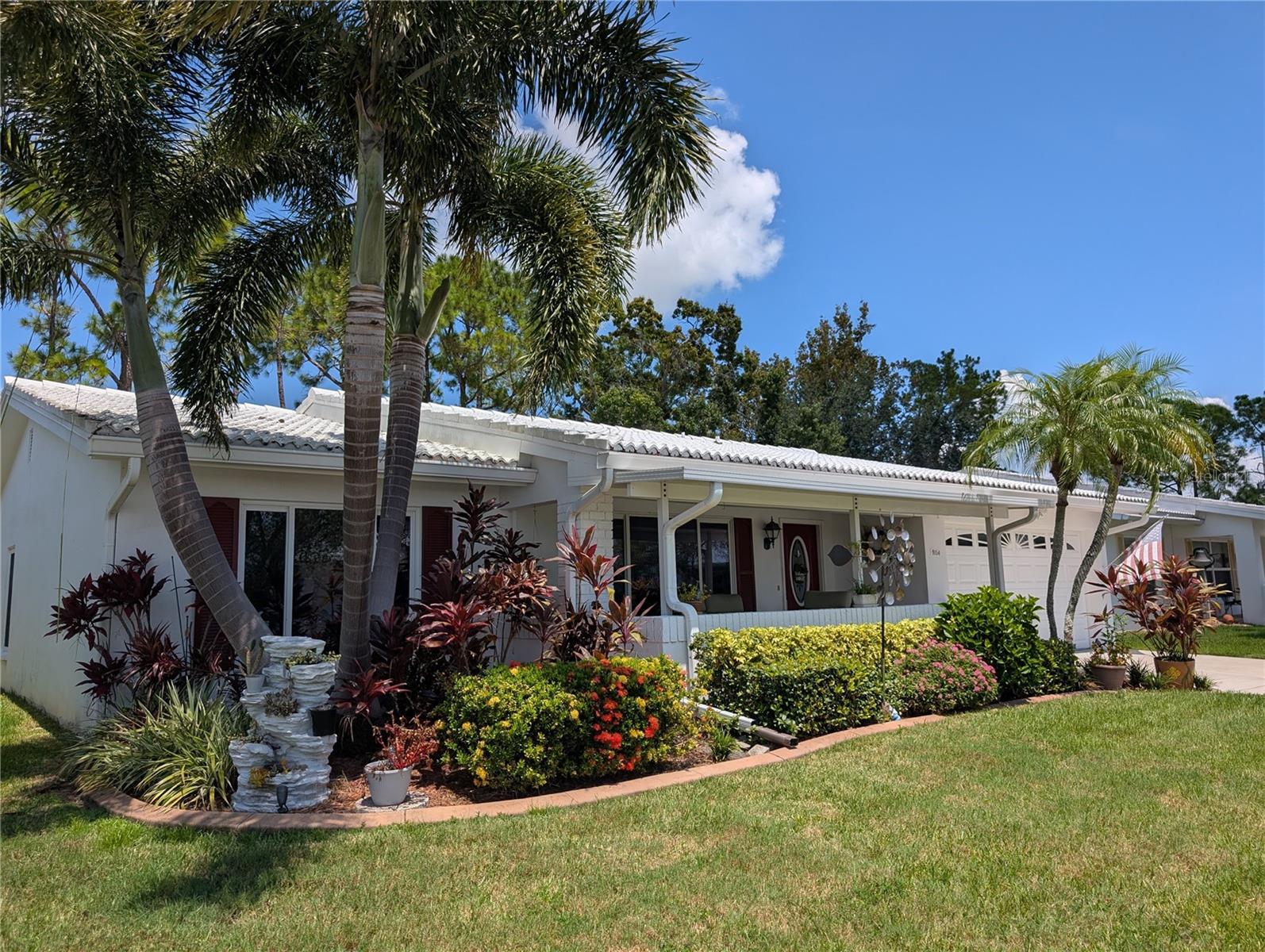 "WOW" a phenomenal "Gormay" with a great location!! Clubhouse is a stone throw away, the golf course is just a chip & putt away. This pristine 2BR/2BA/2CG open concept home showcases "Pride of Ownership" inside & out. Visitors are welcomed by a well-manicured mix of tropical/rustic landscaping accented w/cement curbing (2021). Attention to detail continues to the interior…this home won’t disappoint! Interior features include soft soothing décor, blonde engineered hardwood flooring, custom Hunter Douglass Silhouette window treatments, 4" baseboard trim, crown molding, newer ceiling fans/lighting w/remotes as well as beautifully updated kitchen & baths. Living/Dining/Florida & Sunroom all surround the "Heart of the Home"... the kitchen. This gorgeous kitchen features numerous updates: granite countertops, glass tile back splash, custom Maple cabinets w/matte black hardware, stainless steel appliances (WP refrigerator w/ice maker (2020), GE Monogram dishwasher, GE glass cooktop (2021), GE built in wall oven & GE microwave hood (2019)), an exquisite matte black custom faucet, undermount stainless steel sink, disposal, undermount cabinet lighting (no dome) & built-in desk/office area w/window installed for extra light. Impressive Sunroom features a stunning bifold glass door & direct access to the awesome back lanai (2018) w/custom Gemstone Diamond coated floor (2021) & back open patio (great spot for grilling). A wonderful space to relax & enjoy Florida outdoor living. A stunning stone electric fireplace is focal point of Florida room which also offers 3" faux wood blinds & a pass thru window to kitchen...a great feature when entertaining. Dining room is centrally located off kitchen between the Living & Florida room. Both spacious bedrooms feature walk-in California style closets, ceiling fans w/lights & blonde hardwood floors. Renovated bathrooms include: granite countertops, maple vanities, comfort height commodes, porcelain tile floors, hardware, mirrors & lighting. Master ensuite bath offers beautifully tiled walk-in shower. Guest bath offers an updated tiled backsplash bathtub/shower area. Exterior features include:  pavered (2021) pet friendly fenced (2019) front porch w/composite roof (15), 7" gutters w/Leaf Guards (2019), tinted (2019) heavy duty double pane windows (2000), tile roof (2002), French drain (2019) & keyless entry. Garage offers: 3-ton, 15-seer Trane HVAC (2018), 200-amp Eaton electrical panel (2018), AO Smith 40-gal water heater (2013), pull down attic access, workspace/custom built in storage, Genie door opener, Clopay garage door & exterior side door. Laundry, also located in garage, offers WP washer/dryer set & utility sink. Unit 5 welcomes 2 pets! Monthly maintenance fee of $342.89 includes lawn care/irrigation maintenance, exterior painting/power washing, water/sewer/trash, internet/cable in addition to maintaining all community property (clubhouse, pool, roads, sidewalks, lakes)! Mainlands of Tamarac by the Gulf Unit #5 is very active, 55+ community offering a clubhouse, heated in-ground pool, shuffleboard courts, public golf course & many other activities. A Tropical Paradise located in the "Heart of Tampa Bay" centrally situated between St. Petersburg, Clearwater & Tampa. Additional conveniences include lots of nearby shopping, sporting/cultural venues, excellent medical/emergency care facilities, restaurants, banking, churches as well as easy access to Gulf coast beaches, US-19, I-275 & two airports.