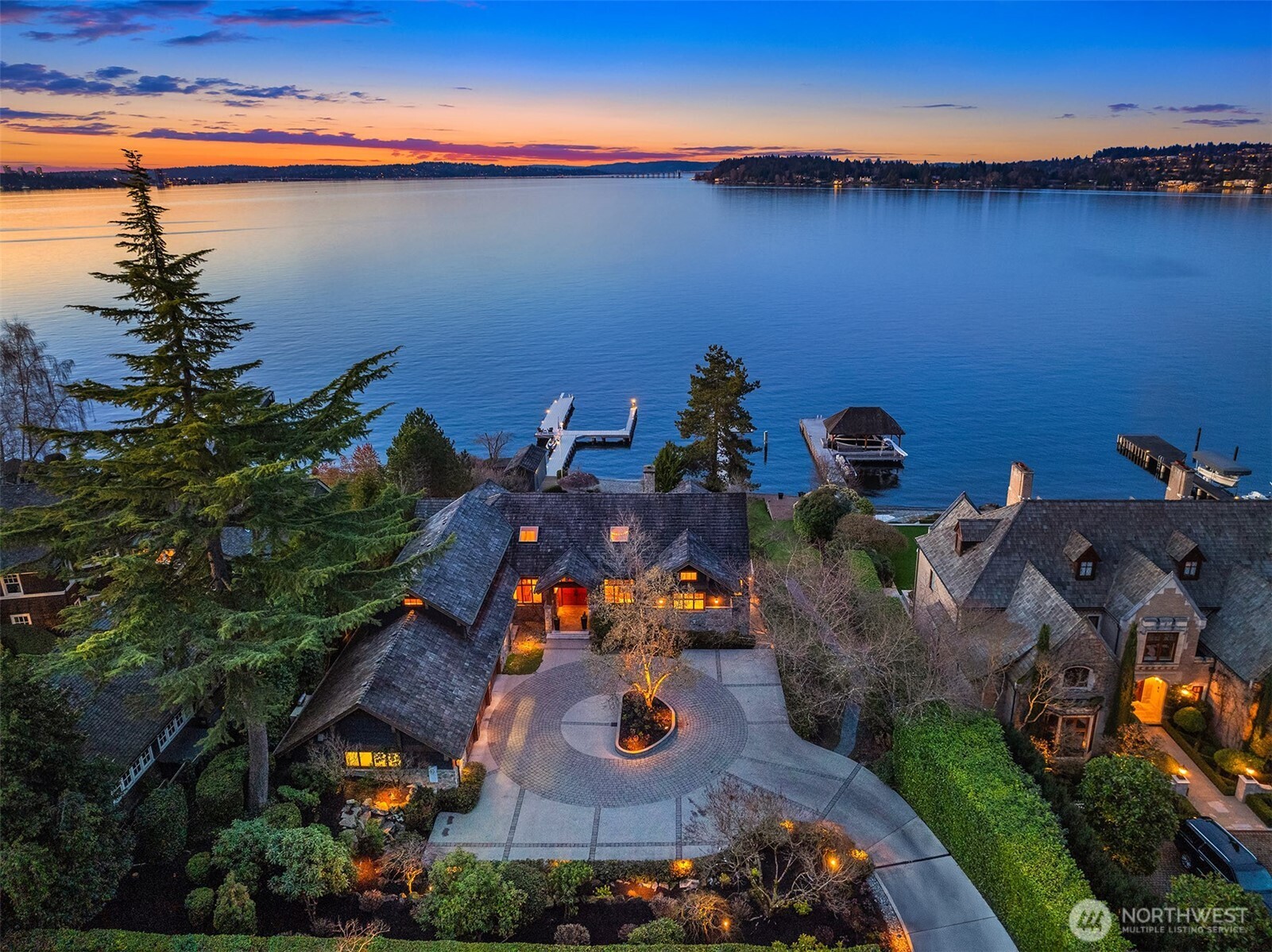 Taking its place among the most significant estates on Mercer Island, this rare waterfront offers 85 feet of lakefront in one of the Island’s most sought-after locations: The North End. The quiet, serene, expansive view sweeps from golden sunsets over Seattle in the west to the twinkling Bellevue skyline and majestic Cascades in the east. Over 7000 SF of living space including main floor primary suite with a front row to the view. Timeless Northwest design with heavy timbers & incredible craftsmanship all meticulously maintained by the owner. Resort living at its best: entertain poolside or at your private beach overlooking the 180-degree view. Fabulous auto court for easy parking. Rebuilt deepwater dock for ~100’ yacht & rare boat house.