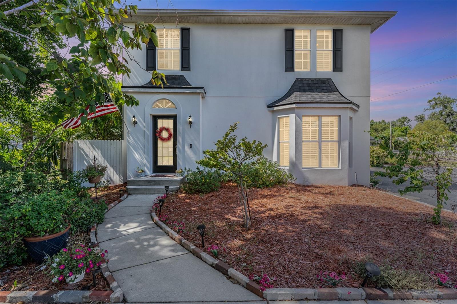 One or more photo(s) has been virtually staged. Step into storybook charm with this beautifully updated English Tudor-inspired two-story home, featuring a crisp transitional exterior and timeless architectural character. Classic charm meets modern updates in this renovated Palm Harbor home, offering 3 bedrooms, 2.5 bathrooms, and thoughtful improvements from top to bottom. The 2019 renovation included a complete kitchen remodel with stainless steel appliances, stylish cabinetry, and granite countertops, plus updated bathrooms showcasing quality finishes and enduring design. Other highlights include wood flooring throughout the first floor, updated fixtures, and a new roof in 2024. As you enter, decorative columns define the living and dining spaces, which flow seamlessly to the backyard and workshop through French doors. Natural light fills the home, including the eat-in kitchen, where white shaker-style cabinetry, a large island, and newer appliances create a perfect space for the home chef. A powder bath and laundry are conveniently located on the main floor before heading upstairs to the bedrooms. The spacious primary suite includes a roomy bath with dual vanity, separate shower, and a large walk-in closet. Two secondary bedrooms share an updated hallway bath with new finishes. Outside, enjoy ample yard space for outdoor living or boat/RV storage, all with no HOA and unincorporated Pinellas County flexibility. The property also includes an 1,152-square-foot building currently used as an office, workshop, and in-law suite—the versatility of this mixed-use property is endless, offering space for work, creativity, or guests. Centrally located just a short golf-cart ride to vibrant Downtown Palm Harbor, and minutes from marinas, top-rated golf courses, Tampa International Airport, shopping, and Gulf beaches. This home perfectly blends modern comfort, classic architecture, and an unbeatable location!