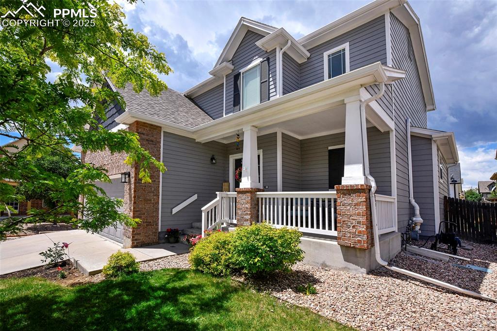 Charming Two-story Brick and Wood home near shopping, schools and Woodmen! Welcoming front porch with room for seating to enjoy the neighborhood in the evening. 7' wide entry provides space for bench seating, and LVP flooring throughout the main level. Open floor plan has sizeable great room and eat-in walk-out kitchen with granite counters, subway tile backsplash, pantry and newer stainless appliances including Refrigerator, flat-top range/oven, microwave oven, and dishwasher. Main level also has laundry room off two-car garage with shelving & 2nd fridge, and powder room for guests. Upper level Master has attached master bath with double vanity, as well as a walk-in closet with built-ins. Two more generous bedrooms, a full bath and loft area with pony walls for a home office, study area, work out area or nook. Large fenced backyard has spacious Trex Deck partly covered with pergola, small deck to accommodate the doggie door in the powder room, Mature landscaping and side gate access. Blinds throughout the home, Ring doorbell, and TV mounts all stay with the home. Welcome Home!