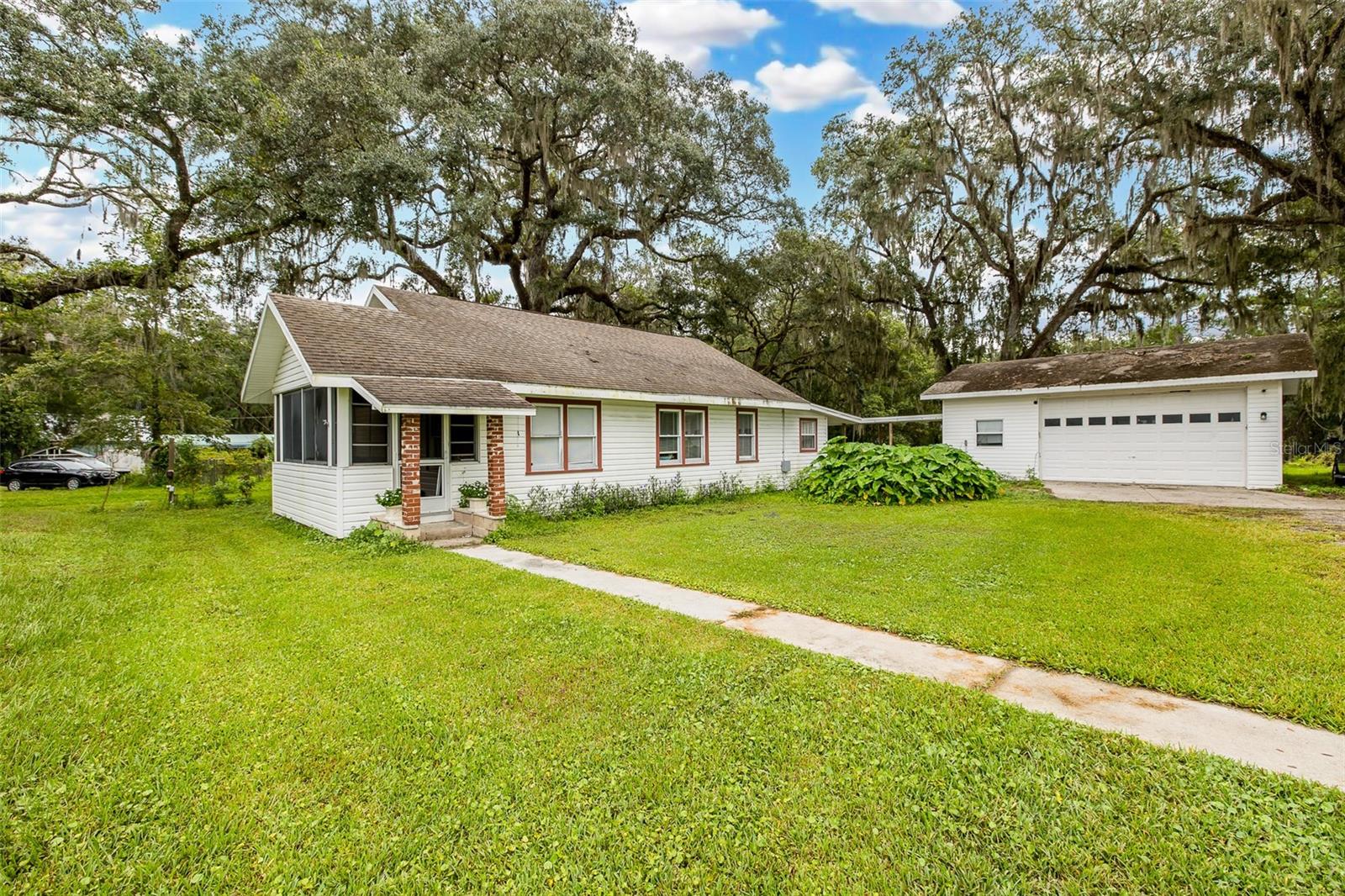 Nearly 2.5 Acres, a 1946 Charmer & a Garage That Means Business!Looking for a home with character? How about character, acreage, history, and a garage that could probably run its own small business?Welcome to this charming 1946 Brooksville original, sitting on nearly 2.5 acres right in historic downtown. Yes, you read that correctly—almost 2.5 acres, downtown. Because apparently, this property didn’t get the memo that downtown living is supposed to mean giving up your elbow room.The home features 2 bedrooms (can be 3 bedrooms), 2 bathrooms, and an office/bonus room—perfect for working from home, hobbies, guests, or that room you swear will eventually be organized. The kitchen has been updated with granite countertops, soft-close cabinets and drawers, and white GE appliances, because even a 1946 house deserves some modern conveniences. And then there’s the 680+ square-foot detached garage that was built in 2004. This isn't your average “park the car and stack some Christmas decorations” garage. With an upgraded 100-amp electrical system, 30-amp shop air connection, and 50-amp welder/RV outlet, this space is ready for projects, toys, tools, hobbies, a workshop—or whatever adventure you have in mind. The property also features a 200-amp electrical system and an upgraded septic system, including the tank, drain field, mound, dosing pump, and high-water alarm system. Best of all, you're close to Brooksville's local shops, historic buildings, restaurants, and downtown charm, while still having enough land to breathe. This is the kind of property that makes people say, “Wait… they don't make them like this anymore.”  And they're right.Historic charm. Modern upgrades. Nearly 2.5 acres. A seriously impressive garage. Downtown convenience.Come see why this one is more than just a house—it's a little piece of Brooksville history with plenty of room for whatever comes next.