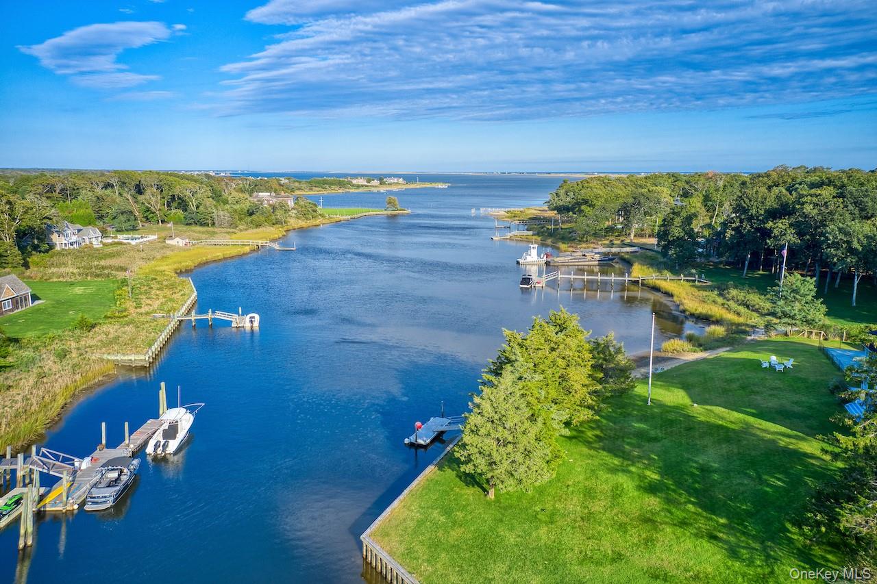 Coming Soon! Summer Estate on Stone Creek Down a 600’ tree-lined drive, this 8-bedroom, 7-bath waterfront estate sits on nearly 5 private acres. Features include 350’ of bulkhead with floating dock, 100’ of sandy beach, pool with pool house, plus expansive entertaining decks and wrap-around porches with sweeping water views. The ultimate Hamptons retreat at 11 Bay Road, Quogue.