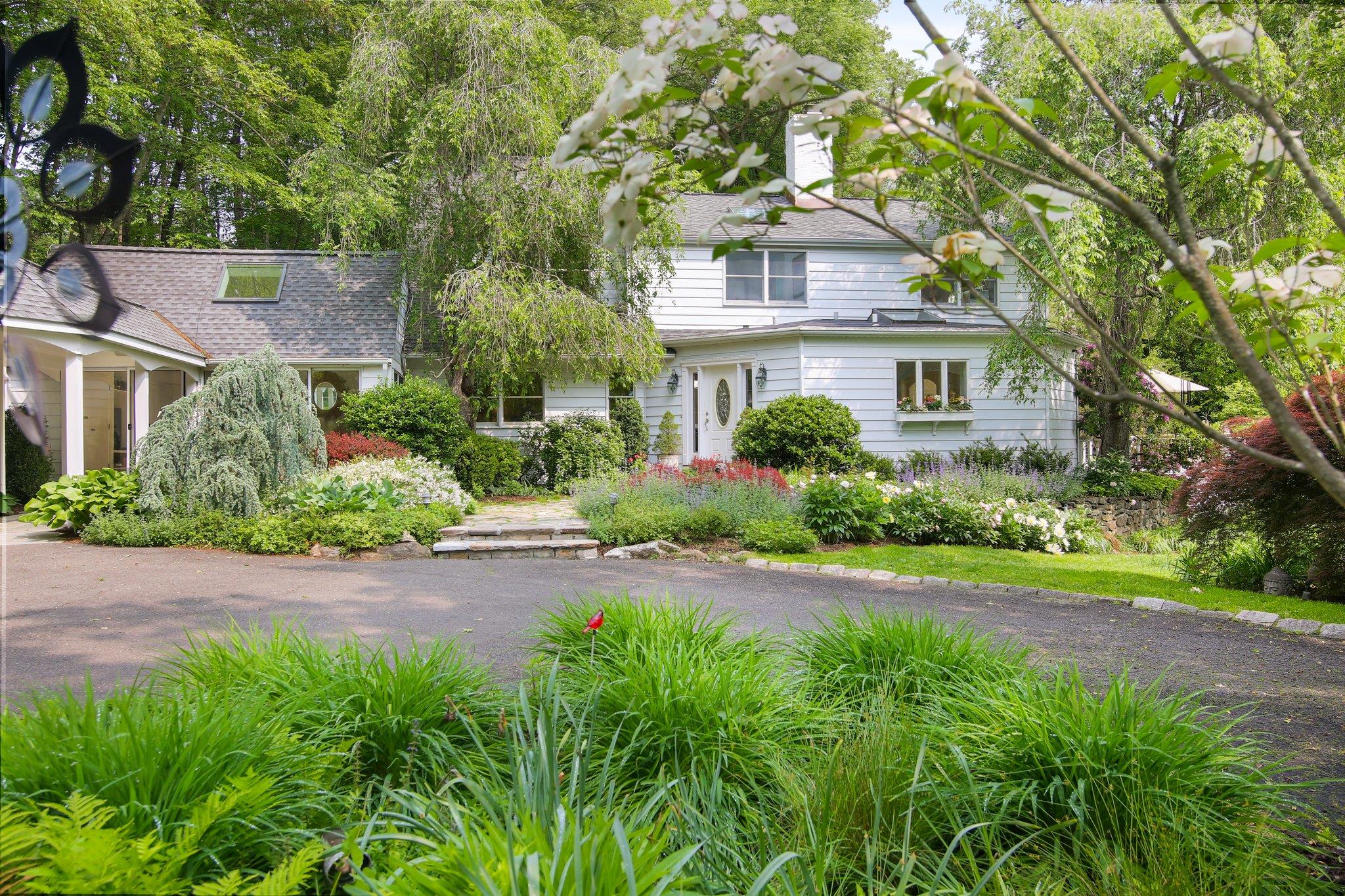 Beyond the stonewalls lies a magical property at 27 West Lane. On almost 4 acres of exquisitely landscaped property with  sweeping lawns and luscious flowering bushes, fruit bearing trees, bees and hummingbirds, where nature abounds in all its glory & just 3 minutes to amazing Scott’s Corner and wonderful shopping. This lovingly expanded Cape with over 3900 sq. ft, four bedrooms, 3 1/2 bath with a large bonus room ( not included in sq ft) over a three car garage completes this dreamy abode.
Oversized windows, streaming with sunlight, open flow perfect for entertaining , cathedral ceilings with beams and hardwood floors with a beautiful light and airy chefs eat in kitchen has access to an open deck with vista views of the property and Pristine views from almost every window. Take a dip in the zen-like pool with the magical and meditative gardens. 
Loads of storage and closets throughout, generator, and finished basement for your enjoyment along with large unfinished area.  A home to behold and cherish forever, which will bring glorious memories to all…in every season of your life. (4400 sq ft includes partially finished lower level of 450 sq ft.)