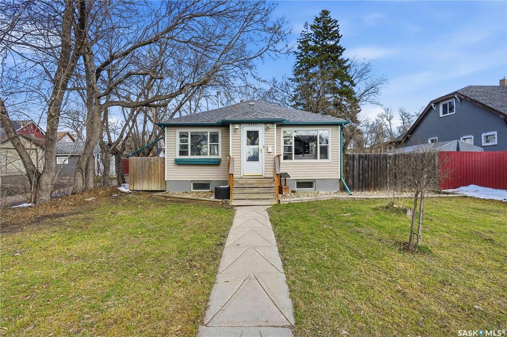 Welcome to this charming 840 sq. ft. home nestled in the highly desirable Arnhem Place neighborhood, just steps from beautiful Wascana Park. Offering 3 bedrooms and 2 bathrooms, this property is perfect for families, first-time buyers, or anyone looking to enjoy a well-established community with plenty of green space nearby.Inside, you’ll immediately notice the abundance of natural light streaming through the large, upgraded windows. The bright, modern kitchen features crisp white cabinetry and a full appliance package, creating a clean and functional space for everyday living. The beautifully maintained hardwood flooring flows throughout the living room, hallway, and bedrooms while the kitchen and main floor bathroom showcase newly installed vinyl plank flooring. Neutral paint tones throughout the home provide a fresh, move-in-ready feel. The two main floor bedrooms are generously sized and thoughtfully separated by a beautifully updated, modern 4-piece bathroom, offering both comfort and privacy.The fully developed basement expands your living space with an expansive rec room, a third bedroom (window may not meet egress), a 3-piece bathroom, and a comfortable laundry area. Updated carpet adds warmth and comfort to the lower level.Situated on a lane location, this property offers added privacy from neighbors. The fully fenced backyard is ideal for entertaining and relaxing, complete with a deck, patio, firepit area, garden boxes, and a single detached garage.Set on a generous double lot, there’s ample room to build your dream garage while still maintaining plenty of yard space for kids or pets to enjoy. With a long list of improvements already completed, this home is ready for you to move in and make the most of the upcoming summer months.