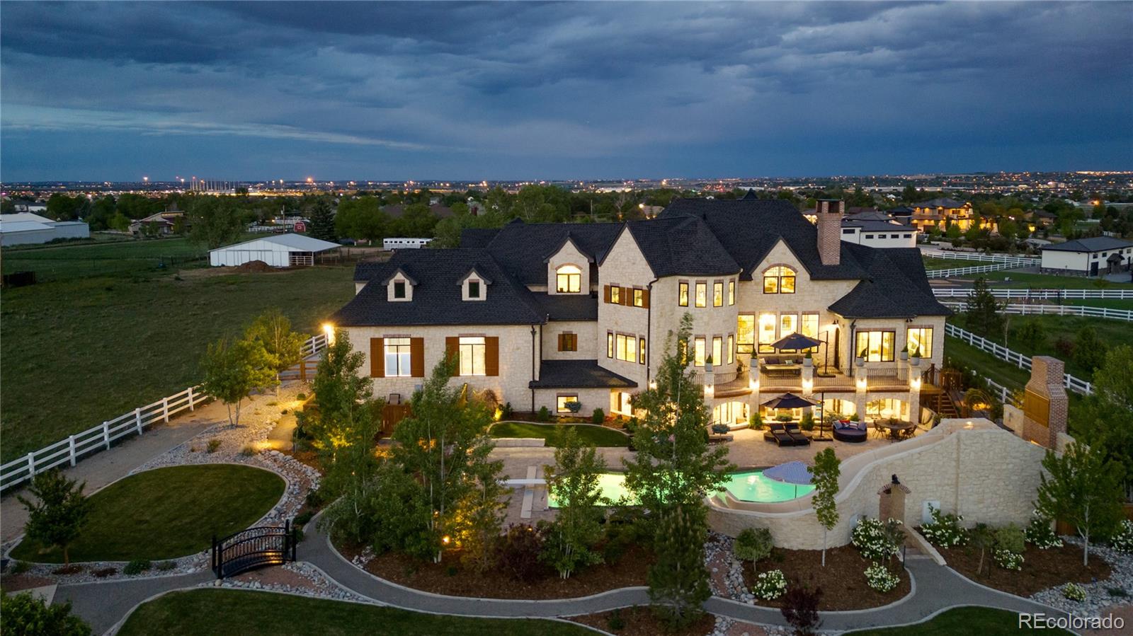 A property like this rarely ever comes for sale—especially in Broomfield. Set on over three beautifully landscaped acres with no HOA and no metro district, this one-of-a-kind estate offers privacy, luxury, and unmatched freedom.

A gated entrance and stunning ¼-mile tree-lined driveway lead to lush gardens, manicured lawns, and resort-style amenities. The backyard is built for unforgettable fun: a heated pool, private spa area, custom outdoor water slide, and multiple patios for entertaining. There's also a pickleball court, basketball court, and room to comfortably park over 80 vehicles—ideal for hosting large gatherings.

Inside, the home is filled with character and quality—from DuChâteau wide-plank wood floors to arched storybook doors and a 72” French LaCanche range. The walk-in pantry with rolling ladder and locally crafted cabinetry reflect thoughtful design throughout.
The walkout lower level is pure fun: a custom wood slide from the main floor, an indoor trampoline, climbing wall, foam pit, theater, and a full second kitchen—perfect for parties or multi-generational living.

There is plenty of room for a detached RV garage/office (conceptual plans included). And also available for purchase ($1,250,000) is a fully buildable 1.59 acre lot, perfect for constructing a second complete residence.

It’s not just a home—it’s an experience. And it’s something you won’t find anywhere else in Broomfield all just minutes from Denver, Boulder, and DIA.