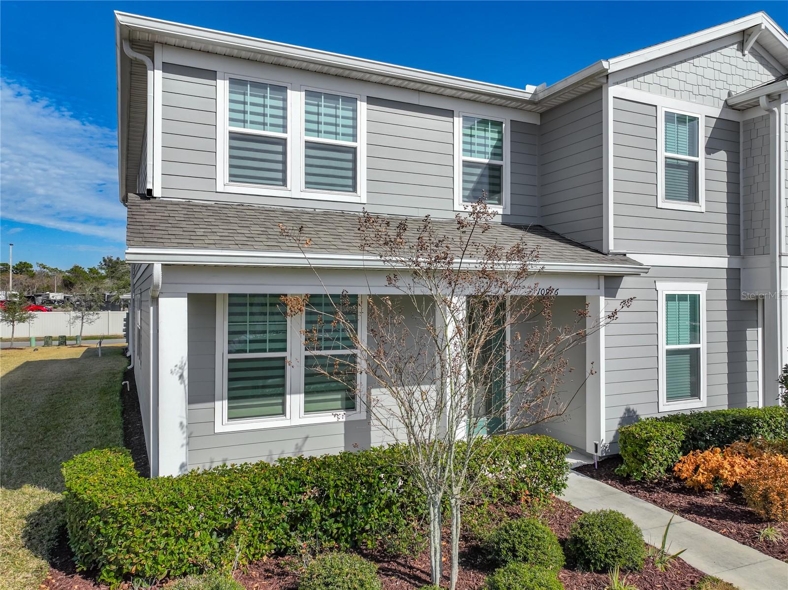 This impeccably maintained two-story end-unit townhome offers modern finishes, energy-efficient features, and a functional layout designed for comfortable living. The covered front porch and glass front door with built-in privacy blinds create a welcoming first impression.Inside, the spacious foyer opens to a bright, open-concept living and dining area filled with natural light. The layout allows flexibility for furniture placement and entertaining. Ceramic tile runs throughout the first floor, offering both style and easy upkeep.The kitchen features stainless steel appliances, an undermount sink, quartz countertops, and a large island with breakfast bar seating. Designer cabinets with crown molding provide generous storage, along with a walk-in pantry and an additional storage closet. Decorative pendant lighting, recessed LED lights, and an upgraded faucet add subtle modern touches. A conveniently located half bath completes the main level.Upstairs, all bedrooms are privately situated with plush carpeting throughout. The primary suite includes a walk-in closet and an ensuite bath with dual sinks, a tiled walk-in shower with frameless glass enclosure, and a private water closet. Two additional bedrooms have built-in closets and share a full bathroom with a tiled tub and shower combination.The private, fully fenced courtyard with concrete pavers is located just off the kitchen—ideal for relaxing, gardening, or gathering with guests. A covered walkway connects the home to the two-car garage, and a full driveway provides additional parking. Additional features include a convenient and reliable built-in pest control, The community offers guest parking, a playground, and access to Pinewood Reserve amenities including a pool, walking trail, and additional playground. Conveniently located near SR-417 with easy access to Downtown Orlando, UCF, Orlando International Airport, and Lake Nona. Close to local schools, including Orlando Science Middle/High Charter School.Shows like a model! Move-in ready and easy to maintain—schedule your showing today. Hablo español.