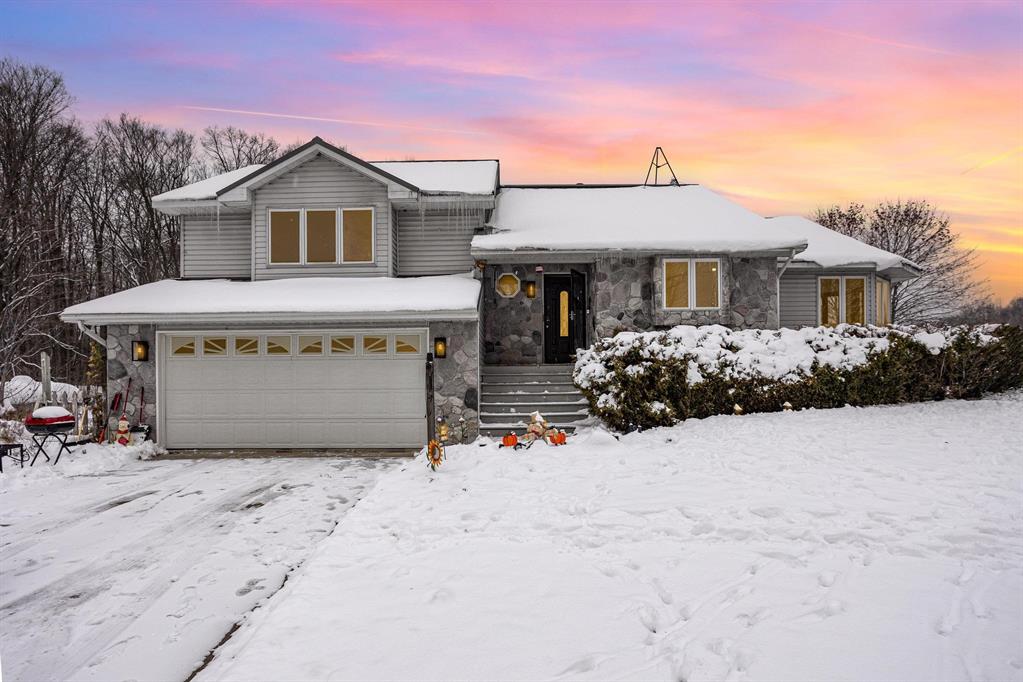 Opportunities like this rarely hit the market: 40 acres of privacy, multiple insulated outbuildings, and a completely modernized home all packaged into a single, turn-key estate. This fully updated 3-bedroom, 3-bath property offers 2,374 sq ft of living space across two finished levels plus an additional 1,141 sq ft of finished basement space with a full bathroom and a dedicated laundry room, paired with exceptional exterior storage that includes a two-car attached garage, a three-car detached garage measuring 30'x38' with electricity, 3-inch insulation, and a concrete floor, two connected pole barns measuring 56'x40' each with attached 16'x56' lean-tos, and an additional 80'x40' pole barn that is fully insulated, wired with electricity, and finished with a concrete floor. The land itself is stunning, with a gently rolling terrain made up of a mix of mature woods and open ground-offering the perfect balance of privacy, wildlife habitat, and usable acreage. Inside, the home features waterproof LVP flooring throughout, vaulted ceilings, expansive windows overlooking the acreage, and a fully remodeled kitchen with quartz countertops, high-end appliances, and sleek high-gloss cabinetry. The expansive primary bedroom provides a true retreat with its own private full bath, and the remaining bathrooms have been upgraded with premium tile and fixtures. The dining room is wrapped in windows with panoramic views, and the finished lower level offers impressive extra living space with walk-out access, ideal for entertaining, guest quarters, or a home office. With woods, trails, wildlife, and endless opportunity for recreation, hunting, farming, or building-and the option to purchase fully furnished-this property delivers an unparalleled combination of land, versatility, and modern comfort in one rare offering. Call to schedule your private showing today.