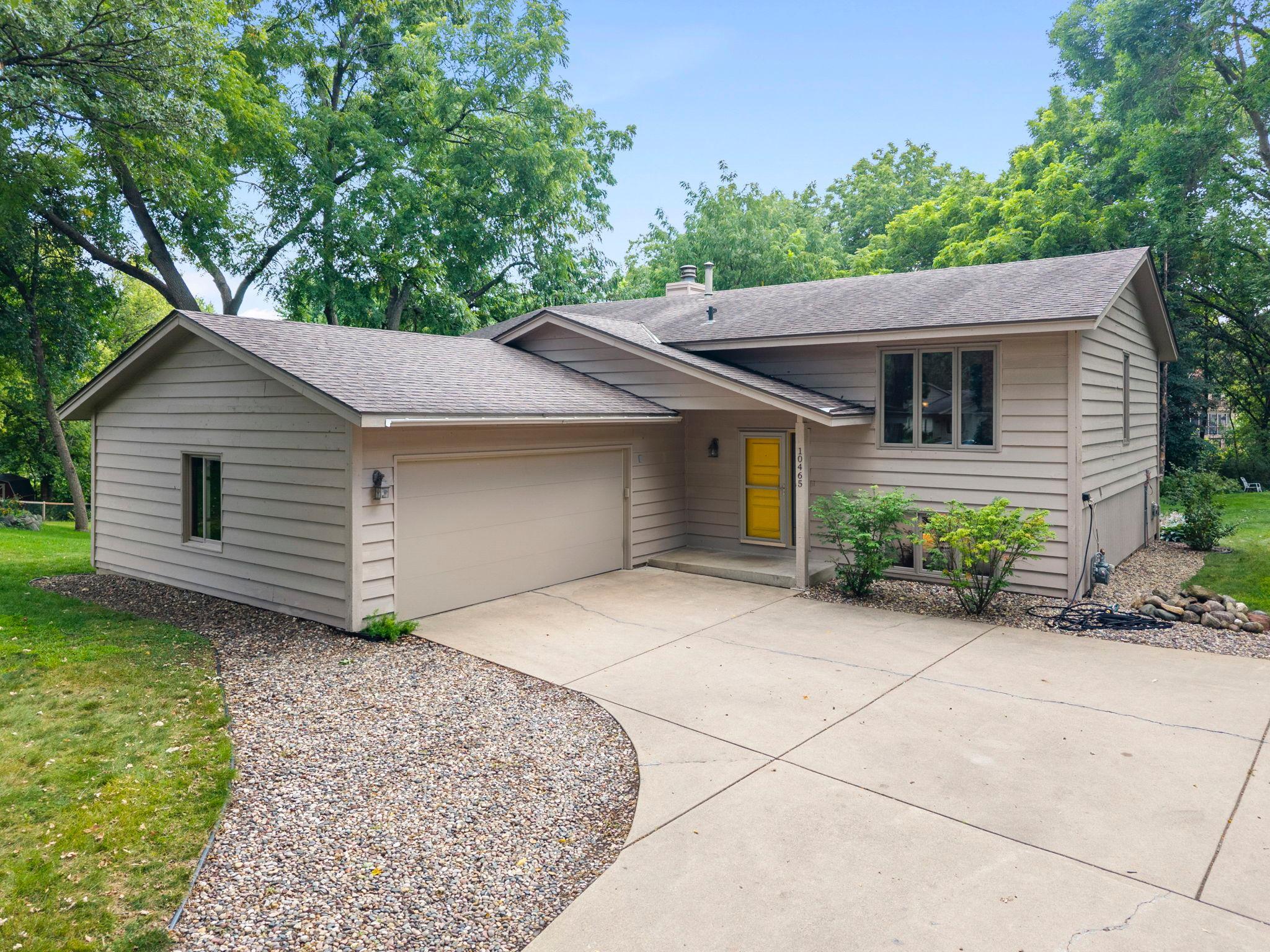 Welcome to this charming 4-bedroom, 2-bathroom home nestled on a wooded lot in a quiet Eden Prairie cul-de-sac. Ideally located within walking distance of Olympic Hills Golf Club with easy access to Highway 169, I-494, shopping, dining, and local amenities. The inviting main level features a spacious living room with vaulted ceilings, a well-appointed kitchen with abundant cabinetry and eat-in area, formal dining room, and family room with wood-burning fireplace and access to the screened-in three-season porch. Two bedrooms, including a spacious primary with walk-in closet and walk-through full bathroom, complete the main level. The finished lower level offers a comfortable family room with gas-burning stove with brick surround, wood-paneled walls, built-in shelving, and walkout access to the patio, plus two additional bedrooms and a ¾ bathroom. Enjoy the peaceful, tree-lined backyard from the patio, deck, or screened-in porch, with frequent wildlife sightings. An oversized concrete driveway with basketball hoop and attached 2-car garage add convenience. A wonderful blend of comfort, privacy, outdoor living, and accessibility in a desirable location!