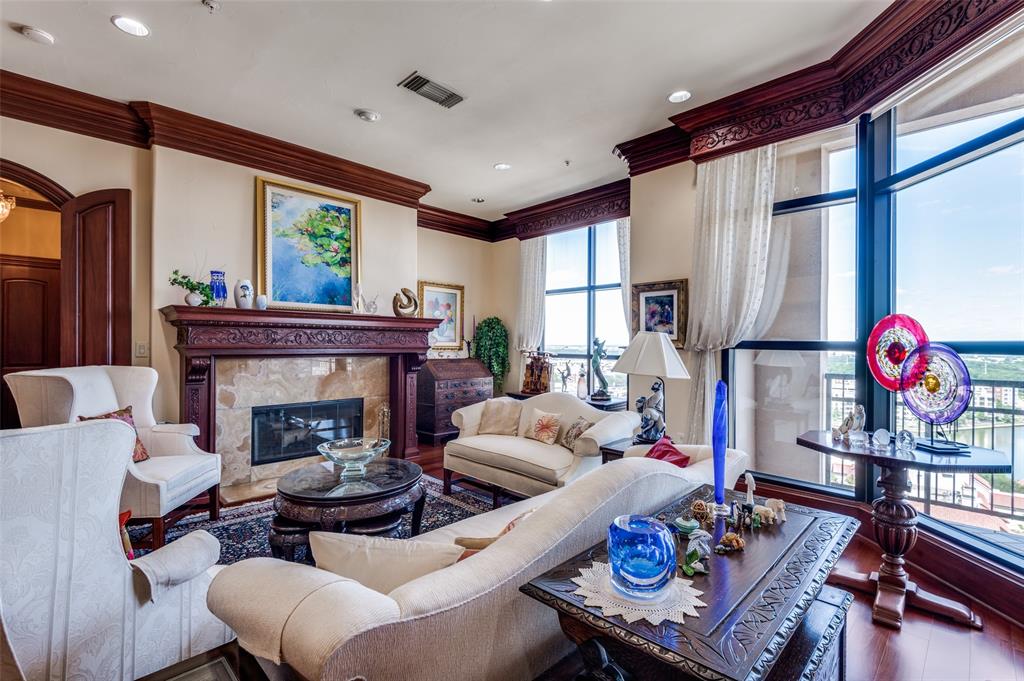 A stunning penthouse and a prestigious address!  Panoramic views on two sides of this unique home in the sky. The open floor plan is perfect for entertaining as well as comfortable family living.  Some of the luxurious features are mahogany and marble floors, gorgeous moldings, many built-in bookcases, high ceilings, window shades and custom-made drapes.  The gourmet Kitchen has an oversized Thermador refrigerator, Bosch dishwasher, large island, granite counters , custom drawers and a warming oven. Either of the two Studies can be a third bedroom.  The Primary Bedroom has amazing views from two directions.  The Primary Bath has Lalique designs, a whirlpool tub, heated towel racks, a marble floor, and a bidet.  The Den has impressive bookcases and a wet bar with an ice maker and wine cooler.  The balcony is lovely day or night with possibilities for parties or just some pleasant quiet time. On a clear day you can see forever.
 There are three parking places, a large storage room and an electric  car charging machine exclusively for this unit.
Grand Treviso  has a 24-hour Concierge service, a rooftop pool, Activity Center, Executive Conference Room, a state of the art work-out facility and a Coffee Lounge. Step across the street to walk around Lake Carolyn and enjoy the many restaurants and entertainment venues in the Toyota Music Factory and Water Street.  This lock and leave penthouse with resort amenities is all about location and low-maintenance.  It was taken back to the studs by the owner and re-built with meticulous care and high-end amenities throughout.  It can become your very own Dream Home.
