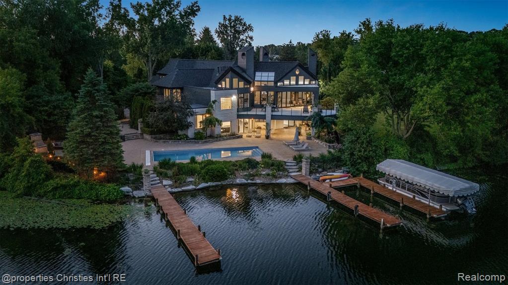 Presenting a once in a lifetime opportunity to own a private island in one of Michigan’s most exclusive all sports lake communities. With a local reputation of prestige and mystique, Lake Sherwood is the pinnacle of lakefront communities in affluent Oakland County and is surrounded by the most bustling upscale metropolis’ in the country, just minutes from downtown Milford. 4912 Oakwood Court is a nearly 1.6-acre legacy parcel tucked at the way back of a conveniently situated cul-de-sac that enjoys 1,500+ feet of prime waterfront and, without its long and elegant tree lined driveway, would be entirely surrounded by pristine waters. This rare island is improved by an architectural masterpiece, a timeless estate home designed to be acquired by a buyer that understands its place as the pride of a truly private, residents only lake. This home features a plethora of natural sunlight, rustic stone fireplaces complete with imported limestone mantles, WOLF appliances, and lustrous white maple hardwood flooring, together crafting one of the finest residences in the state. The fluid layout, and extremely thoughtful features offer the highest degree of functionality for any lifestyle; ultimate control and privacy is one of the many benefits this property offers. The spacious terrace overlooking the resort style pool complete with a breathtaking lake view sits just steps away from the Northern Michigan grown cedar docks that your grandchildren will walk on, which offer permanent docking solutions for your boats. Situated in the “no wake” part of the lake, this ONE of ONE property is mere seconds from the vast oasis that is Lake Sherwood. Every part of the property offers jaw dropping lake views, including the towering outdoor fireplace just off the pool. Complete with spacious and well-manicured rolling grounds fit for a tennis court, an additional structure, or whatever else you decide to feature, this incredible estate is an asset to enjoy and design a lifestyle around.