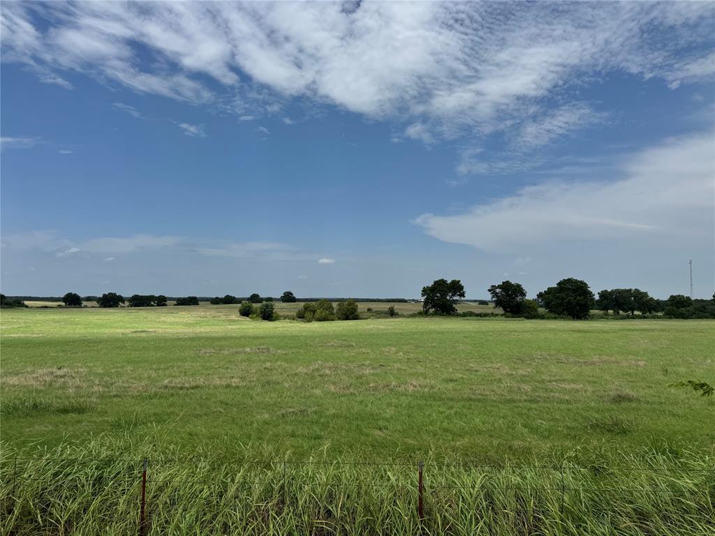 Investment property with over 3,500 feet of paved county and FM road frontage.  Easily divisible into smaller tracts. Covered in highly improved Coastal grass, excellent fencing, great building spots, rolling topography that overlooks two large neighboring ranches. Across the road from Rock Creek Resort and on clear days a hilltop view of Oklahoma.  Grayson County's finest land is found in this area.  Close enough to town but offers a rural setting.