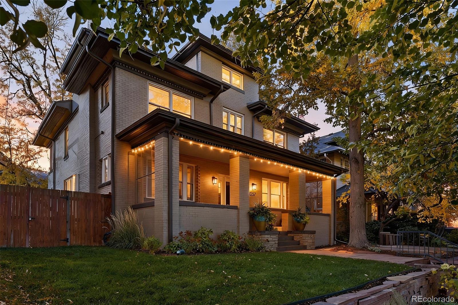 Luxury living in Congress Park is redefined at 1257 Fillmore Street. This stunning 3-story Denver Square has been meticulously renovated for modern living while preserving timeless character. Offering more than 3,700 above-grade square feet and over 5,000 total square feet, the home delivers exceptional scale, design, and functionality across every level. The thoughtfully designed floor plan includes 5 bedrooms, a 3rd-floor loft or bonus space, a dedicated workout room, and 4 beautifully remodeled bathrooms showcasing custom finishes throughout. A classic foyer opens to sun-filled living spaces highlighted by refined trim work, elegant wall coverings, and seamless flow between the formal spaces to the chef's kitchen. At the heart of the home is a show-stopping chef’s kitchen featuring an 8-burner Wolf range, Sub-Zero refrigeration, quartz island, custom mosaic backsplash, and a nano-door wall that opens completely to the flagstone patio—creating effortless indoor-outdoor living ideal for entertaining. The adjacent formal dining room is equally impressive w/custom lighting, wall coverings & ready to host. The second level hosts 4 bedrooms, including a expansive primary suite with hardwood floors, spa-inspired bath with oversized shower, and dual custom closets. 3 additional bedrooms share a designer bathroom with copper sink, penny tile floors, and custom tile work. The 3rd floor offers a versatile retreat—perfect as an office, loft, studio, or private escape among the treetops. The fully finished basement includes a family room w/exposed brick is ready for movies and game night with wet bar, guest suite w/egress, stylish bath w/heated floors, custom tile and wall coverings, laundry room, and additional room for home gym or bonus room. Outside, enjoy a private, fenced yard and patio with coveted southwest exposure, plus a two-car garage and additional storage. A rare blend of historic charm and modern luxury in one of Denver’s most sought-after neighborhoods.
