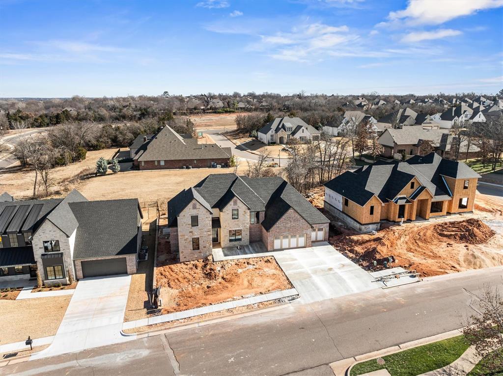 Welcome to a breathtaking residence of distinction in the prestigious Autumn Ridge community at 3032 Fountain Creek Drive in Edmond. Thoughtfully designed to blend refined sophistication with modern functionality, this exceptional home offers an elevated living experience defined by architectural elegance and meticulous craftsmanship throughout. The expansive great room serves as the heart of the home, highlighted by a striking statement fireplace & seamlessly connected to the gourmet lifestyle kitchen, creating an inviting setting ideal for both everyday living and upscale entertaining. The kitchen is a true culinary showpiece, featuring a 48" freestanding gas range with oven, built-in refrigerator, quartz countertops, a stained oak center island, dedicated dining area, and an impressive walk-in butler’s pantry providing exceptional storage. Every detail has been carefully curated to balance beauty with practicality. The primary suite is a private sanctuary, offering a spa-inspired retreat complete with an oversized walk-in shower, pedestal soaking tub, and a custom-designed closet tailored for luxury living. Upstairs, a versatile flex space provides the perfect setting for a media room, or game room, along with two generously sized secondary bedrooms & a full bathroom. On the main level, a fourth bedroom with a private en-suite bath offers ideal accommodations for guests or multigenerational living, while a dedicated home office adds everyday convenience. The backyard invites outdoor entertaining, al fresco dining, or peaceful evenings under the stars. Nestled within a serene, wooded enclave, this home offers enhanced privacy and tranquility surrounded by natural beauty. Autumn Ridge is an established Edmond community featuring resort-style amenities, including a pool, cabana, & playground, perfectly blending peaceful living with modern convenience. Ideally located near shopping, schools, parks, and with easy access to I-35. Completion: April 2026. Welcome home.