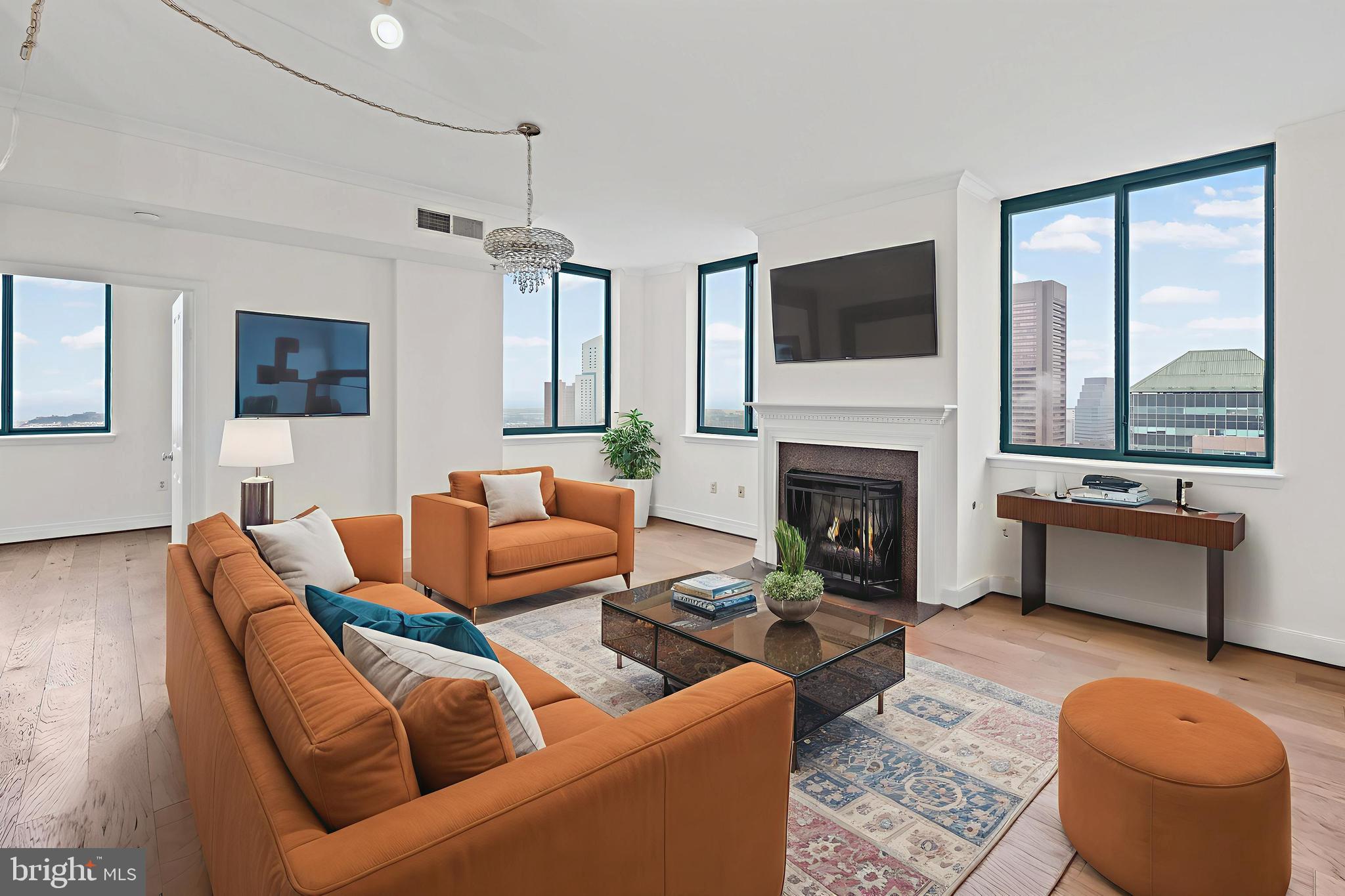 Must-see high-floor luxury corner condo, freshly painted and move-in ready, offering jaw-dropping panoramic Inner Harbor & skyline views, 2 spacious bedrooms + private den, and 2.5 beautifully updated baths in one of downtown’s most desirable full-service buildings. This sun-filled home features hardwood flooring throughout, a gas fireplace, and an open-concept layout perfect for entertaining. The modern kitchen shines with brand-new stainless steel appliances, granite countertops, and maple cabinetry, while the expansive primary suite impresses with a walk-in closet and a spa-inspired bath featuring a soaking tub and separate shower. A second large bedroom, upgraded full bath, dedicated den/home office, in-unit laundry, and a stylish powder room add to its appeal. Enjoy resort-style amenities—outdoor pool, fitness center, clubroom, 24/7 front desk, on-site management—all just minutes from the Inner Harbor, top dining, shops, and commuter routes. Freshly painted, updated, high floor, rare layout—this is the standout listing buyers will click on immediately.