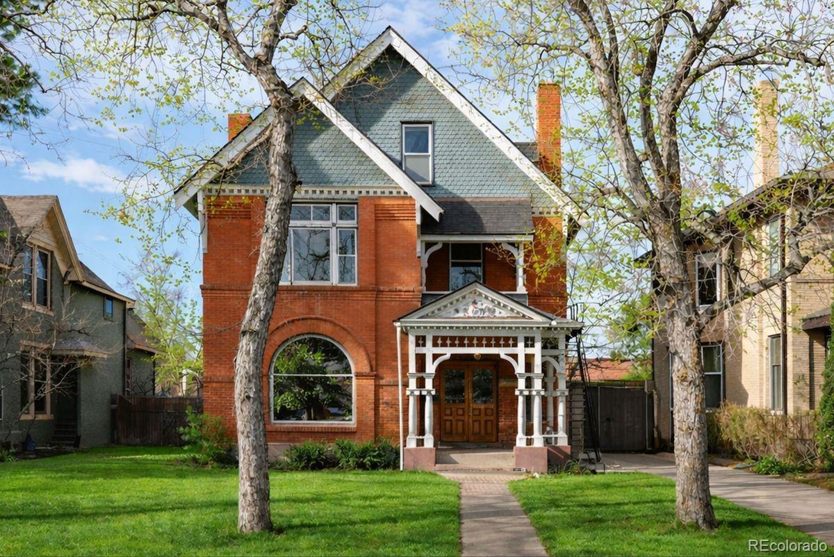 A rare opportunity to own a true Denver Victorian in one of the city’s most desirable, walkable locations—just steps from the Broadway entertainment district, downtown Denver, and the State Capitol. This historic residence blends preserved architectural detail with modern updates, offering timeless character and exceptional flexibility. From the moment you enter, the home makes a powerful first impression with a grand entrance foyer—a true statement space rarely found today—showcasing soaring ceilings, richly preserved original woodwork, a sweeping staircase, and stunning stained-glass windows that flood the home with filtered light. The foyer sets the tone for the craftsmanship throughout —details that speak to a level of historic quality simply impossible to replicate.  The renovated kitchen honors the home’s period charm with custom cabinetry, Thermador appliances, soapstone countertops, and a rear staircase to the second level. The upper floors provide generous and flexible living spaces, including guest rooms ideal for offices or studies, a second-level loft area overlooking the foyer, a conveniently located laundry closet, and a stunning primary suite featuring dual fireplaces, a walk-in closet, and a private balcony. The third level adds even more versatility with additional rooms, a ¾ bath, and a front recreation space pre-wired for entertainment, plus west-facing mountain views—well-suited for conversion into a private rental or guest suite with minimal modification. Alternatively, the basement offers another strong income-producing option, with the ability to create a separate living area for rentals. Outdoors, enjoy a private brick and slate patio, garden beds, and a two-car garage. Rich in history and originally built for one of Colorado’s first city attorneys, this Victorian is unmatched in presence, location, and flexibility—ideal as a primary residence, investment property, or both, and a truly exceptional offering in the heart of Denver.