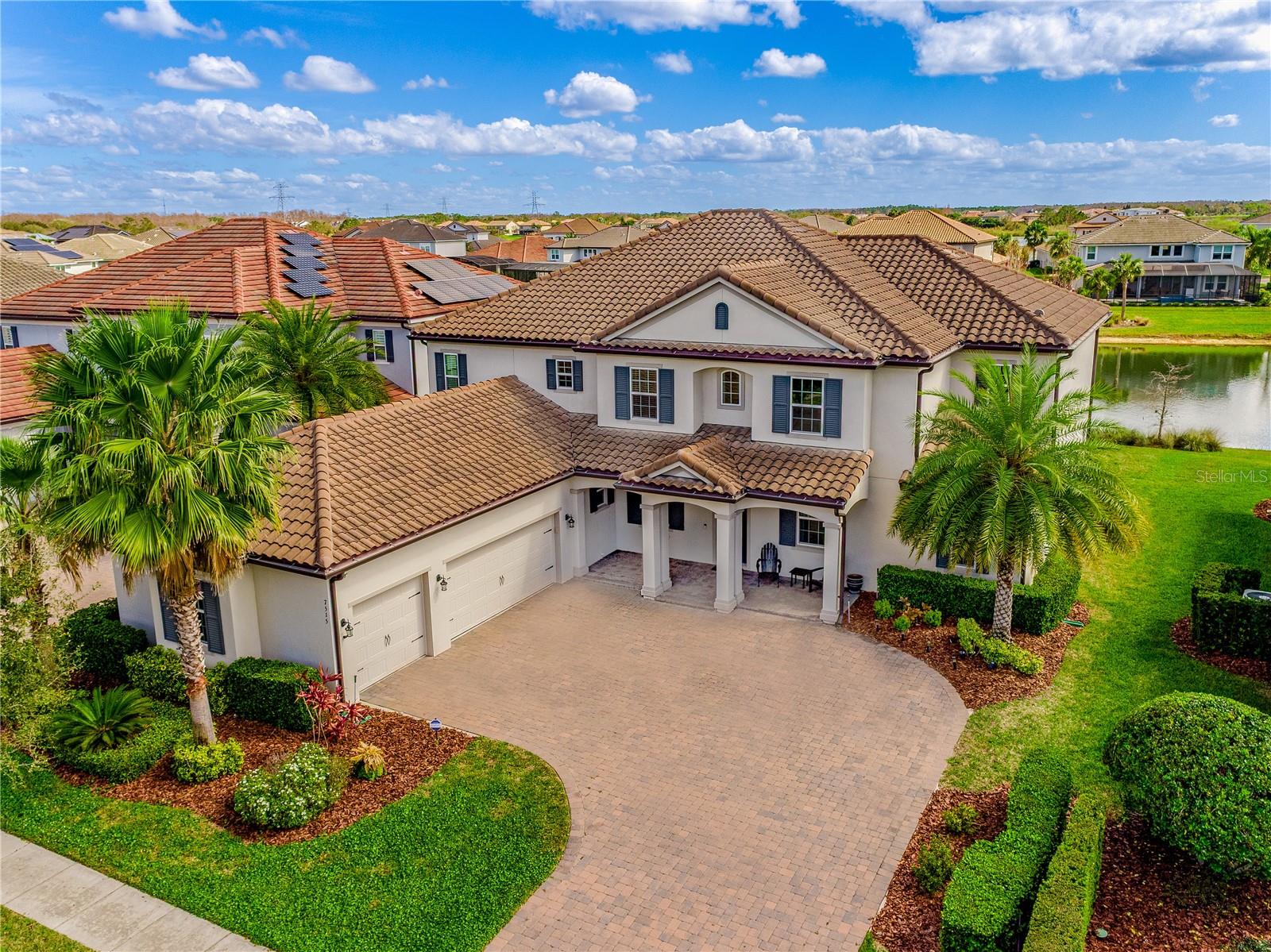 Under contract-accepting backup offers. Perfectly situated within Winter Garden’s premier community - Overlook at Hamlin - this exceptional home offers stunning WATER VIEWS from almost every room, exquisite HARDWOOD FLOORS in a fresh modern tone, a chef’s dream GOURMET KITCHEN, dedicated HOME THEATER complete with SURROUND SOUND, DUAL PRIMARY SUITES (one up/one down!), a 75 YEAR CLAY TILE ROOF for peace of mind for years to come - plus formal, family and flex spaces, RESORT STYLE AMENITIES and access to beautiful LAKE HANCOCK! No detail was overlooked and you will notice that in the many thoughtful UPGRADES and you tour this dream floor plan of 6 SPACIOUS BEDROOMS, 5 FULL LUXURIOUS BATHS and 1 convenient half bathroom. The main floor delivers must-see formal spaces flanking the foyer; a two story living room perfect for hosting guests and across the way a formal dining space adorned in crown molding and finished with a wood slat ceiling. Follow the natural flow into a light and bright family room courtesy of the TRIPLE SLIDING GLASS DOORS that open up to the large screened lanai for ideal indoor/outdoor living and sweeping views of the pond. The family room is open to a kitchen that feels like its been ripped out of the pages of a home magazine with stylish floor to ceiling shaker style cabinetry, sleek stone countertops, DUAL ISLANDS for prep and casual bar seating, desirable STAINLESS STEEL APPLIANCES that include a GAS STOVE, and a WALK-IN PANTRY for ample storage. There are two bedrooms on the main floor; a guest bedroom with a private en-suite bath and your MAIN PRIMARY SUITE. A tranquil escape from the day this space seamlessly blends style and luxury with the upgraded finishes, DUAL WALK-IN CLOSETS and a spa-like en-suite bath that includes a dual sink vanity under decorative mirrors, SOAKING TUB and large separate glass enclosed shower. Upstairs you will find flexible spaces for room to grow in the BONUS/LOFT and theater room, plus three more guest bedrooms and a second primary suite giving you options for overnight guests or visiting in-laws. For the car and hobby enthusiast there is an expansive 3-CAR GARAGE, side facing and paired with immaculate landscaping for unparalleled curb appeal. Owning a home in this vibrant and active community means living the lake life with a resident only COMMUNITY BOAT RAMP and dock on Lake Hancock, swimming in the RESORT-STYLE POOL and enjoying an array of other amenities that include a splash pad, clubhouse, fitness center, community events and so much more! Enjoy views of Disney fireworks nightly from home or spend the day exploring the parks. Zoned for A-RATED SCHOOLS, and you are also just minutes from Hamlin Town Center, shopping, dining, attractions and major roadways like the 429 for anywhere you need to go. Built in 2019 and decked out in tons of upgrades, this home FEELS LIKE NEW and is ready for you to move right in. Call today to schedule a tour and fall in love with your new HOME SWEET HOME in one of the most sought-after areas of Winter Garden!
