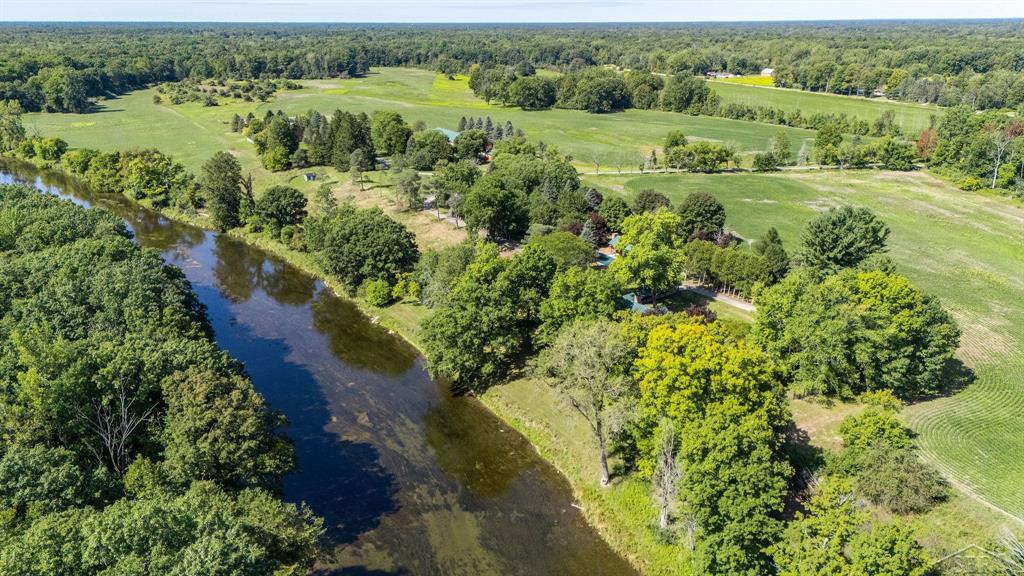 For the first time ever, the historic Anderson/Arbury Farm is being offered for sale-an exceptional property rich in character, history, and opportunity. Situated on approximately 217 acres with an incredible 7,550 feet of frontage on the beautiful Chippewa River & 4950 ft of road frontage, this legacy estate features a Mid-Century Modern home with architectural renovations by Alden B. Dow. The main level of the home offers 1,782 sq ft of living space, complemented by an additional 1,150 sq ft in the finished, walk-out lower level. The home includes two fireplaces, two furnaces, and two AC units, generator, along with an attached two-car garage. Large windows provide stunning views of the river, creating a peaceful and inspiring setting.  In addition to the main residence, the property includes a 25'x19' pool house and pool offering finished living space complete with a murphy bed, fireplace, and full bathroom-ideal for guests or entertaining. The estate also includes four impressive outbuildings with a variety of uses. Two large barns-measuring 160x60 ft and 95x40 ft-both feature cement floors and are fully insulated and heated. The 95x40 ft barn also includes a finished half bath. A third barn is attached to the original barn and features additional finished space (lift not included).  Near the road, there is a 30x32 ft heated garage with a cement floor, providing even more storage.  The land itself is a perfect blend of open farmland and natural riverfront. The farm fields are currently planted with soybeans and under lease until this fall, offering the potential for continued agricultural income or a new vision for the property. Whether you're seeking a private homestead, a working farm, a multi-generational compound, or a unique venue space, this one-of-a-kind property delivers space, history, and flexibility in a breathtaking setting.  This is more than just a property-it's a rare opportunity to own a piece of Mid-Michigan heritage with architectural distinction, versatile outbuildings, and one of the most