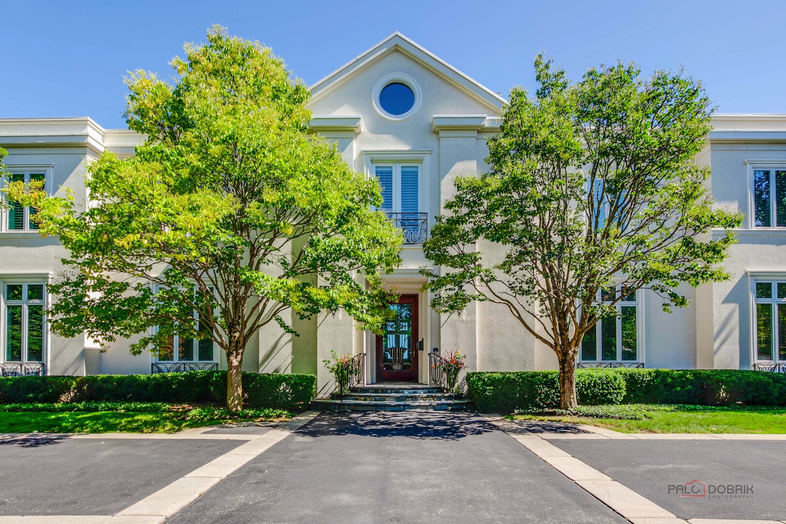 Experience the rare privilege of Lake Michigan living in one of Lake Forest's most distinguished locations, set along prestigious Lake Road. This exceptional Neoclassic home provides an elegant and comfortable lifestyle built for entertaining and offers beautiful lake views, private beach access, and a rare sense of privacy and tranquility. Spacious rooms, high ceilings, custom millwork, hardwood & stone flooring and attention to detail can be found throughout. There is also the added bonus of an elevator to access all three levels.   The formal living room with fireplace features French doors opening out to the bluestone covered patio, creating a sophisticated setting for morning coffee or sunset cocktails. Both the wood paneled library and formal dining room with built-ins provide sweeping lake views. The all white kitchen with center island and light filled eating area features Viking, Subzero and Miele appliances. The kitchen flows into the family room with coffered ceiling and fireplace. French doors provide access to the 4 season bluestone sunroom overlooking the yard and lake. Upstairs are 5 en-suite bedrooms, including the primary suite. The generously sized primary bedroom features 2 walk-in closets, a sitting area with fireplace and a Juliette balcony providing dramatic lake views. Luxury marble bath includes double sinks, Jacuzzi tub and an oversized separate shower. The large laundry room with abundant storage can also be found on this level. Finished Lower Level with high ceilings, 2nd family room with fireplace, huge golf simulator space, full bath with sauna and tons of storage. 4 car heated garage and snow melt driveway. A coveted setting that captures the very best of lakeside living-just minutes from the amenities and charm of Lake Forest.