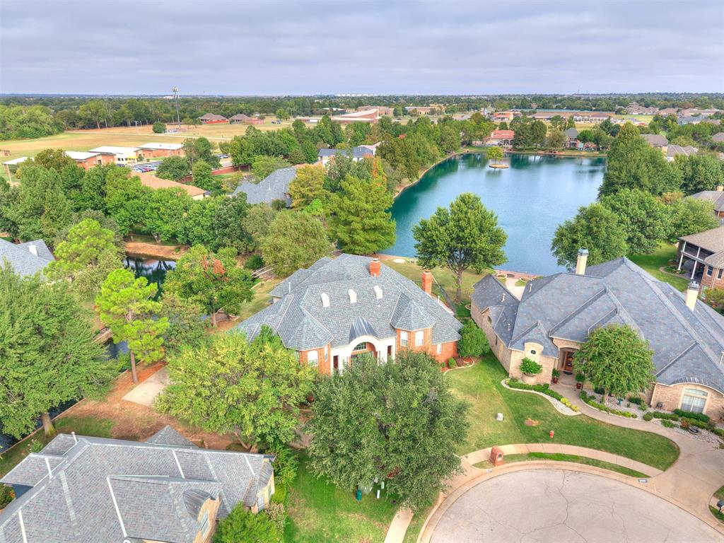 WOW! * WOW! * WOW! * Don't miss this one! * Beautiful home on a Waterfront Lot! * Inground SWIMMING POOL w/HOT TUB, Diving Board and Outdoor Bathroom access * The inside will not disappoint, it features a Large Family Room with Soaring Ceilings, Floor to Ceiling Windows, Lake lot Views, Wood Floors, Cast Stone Fireplace, Built in Aquarium and so much more! * Granite Countertops, Center Island, Pantry, Breakfast Bar, Corner Nook, Stainless Steel Appliances, Crown Molding and Tons of Cabinets make this Kitchen a Chefs dream! * The Primary Suite is a true retreat, featuring a 3 way Fireplace, Backyard access, Jetted Garden Tub, Huge Walk-Through Shower, Double Vanities and Giant Walk-in Closet * A Second Primary Bedroom downstairs with a Full Bath adds versatility to the floor plan with access to it's own private Patio and would be great for multi-generational families * Large Dining Room * Gorgeous Staircase leading Upstairs with 2 Bedrooms with a connecting Bath * Study with Built-in Cabinetry * Theater Room complete with projection TV and Surround Sound * Game Room complete with Pool Table, Wet Bar and Balcony * Hobby/Play/Workout Room with Safe * Outdoor is beautifully Landscaped and features a Sprinkler System, Covered and Open Patios, Balconies, Outdoor Fireplace, Outdoor Kitchen, Koi Pond and even Wrought Iron fencing * Lake Views from your own backyard * Storm Shelter and Wash Room in the 3 Car Garage * Safe * So Many Features to this house, you won't want to miss this one!  Great Location and Great Price too!