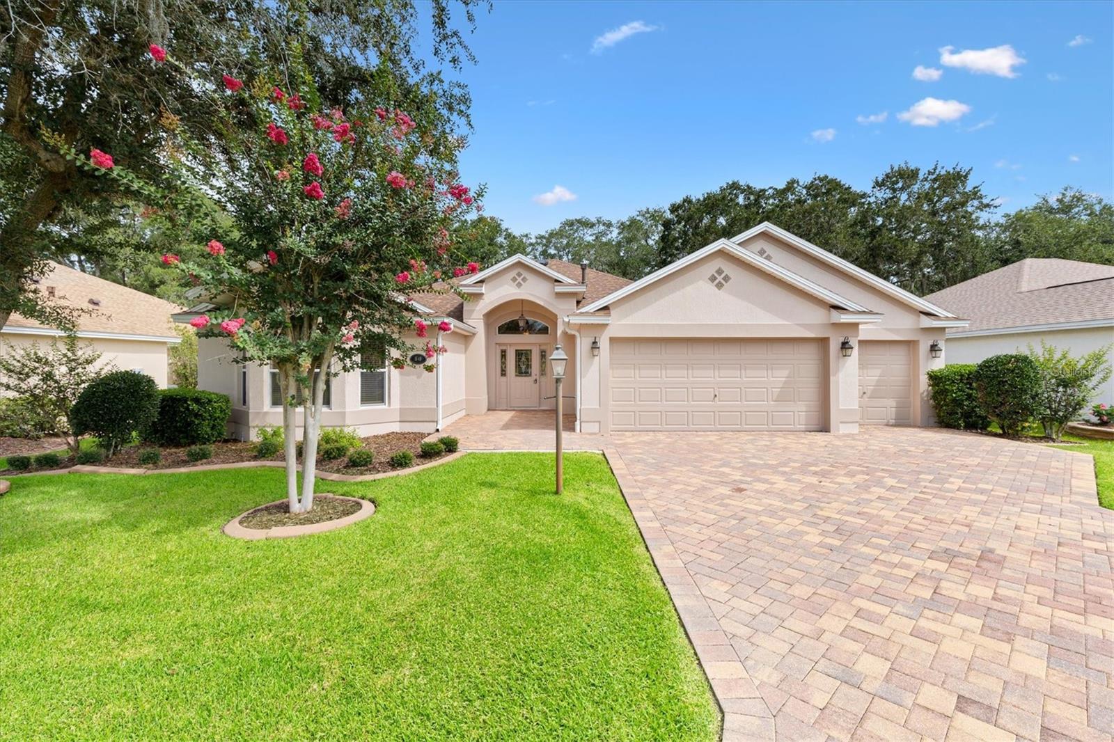 Under contract-accepting backup offers. Experience golf-course living at its finest at 1649 Hartsville Trail in Sunset Pointe, The Villages - a Lantana model showcasing unobstructed panoramic views of the Heron Golf Course and mature tree lines.  Total privacy - you will never see a neighboring home behind this property.  This elegant 3-bed, 2-bath residence (2021 sq ft) welcomes you with a leaded-glass front door, soaring ceilings, double crown molding and abundant natural light through double-paned windows.  The open-plan kitchen boasts granite counters, tile backsplash, breakfast bar, gas range, stainless steel appliances, Samsung refrigerator, new microwave, and a pantry with slide-out shelves.  Enjoy seamless indoor-outdoor living via large sliders from the main living area to a screened lanai overlooking the fairway.  The owner's suite is a serene retreat with walk-in shower, walk-in closet, water closet, and stone counters.  Practical luxury includes a 2-car garage plus golf cart bay, both with electric openers, and pull-down stairs to finished attic storage.  Inside Laundry room includes Maytag washer and dryer, cabinets, and a wall ironing board.  New Roof and Fresh interior and exterior paint in 2026.  3.5-Ton Lennox AC w thermostat (2022).  NO BOND!!  This home is move-in ready for relaxed maintenance-free Village living.  Main Living Area and Master Bedroom have been virtually staged.