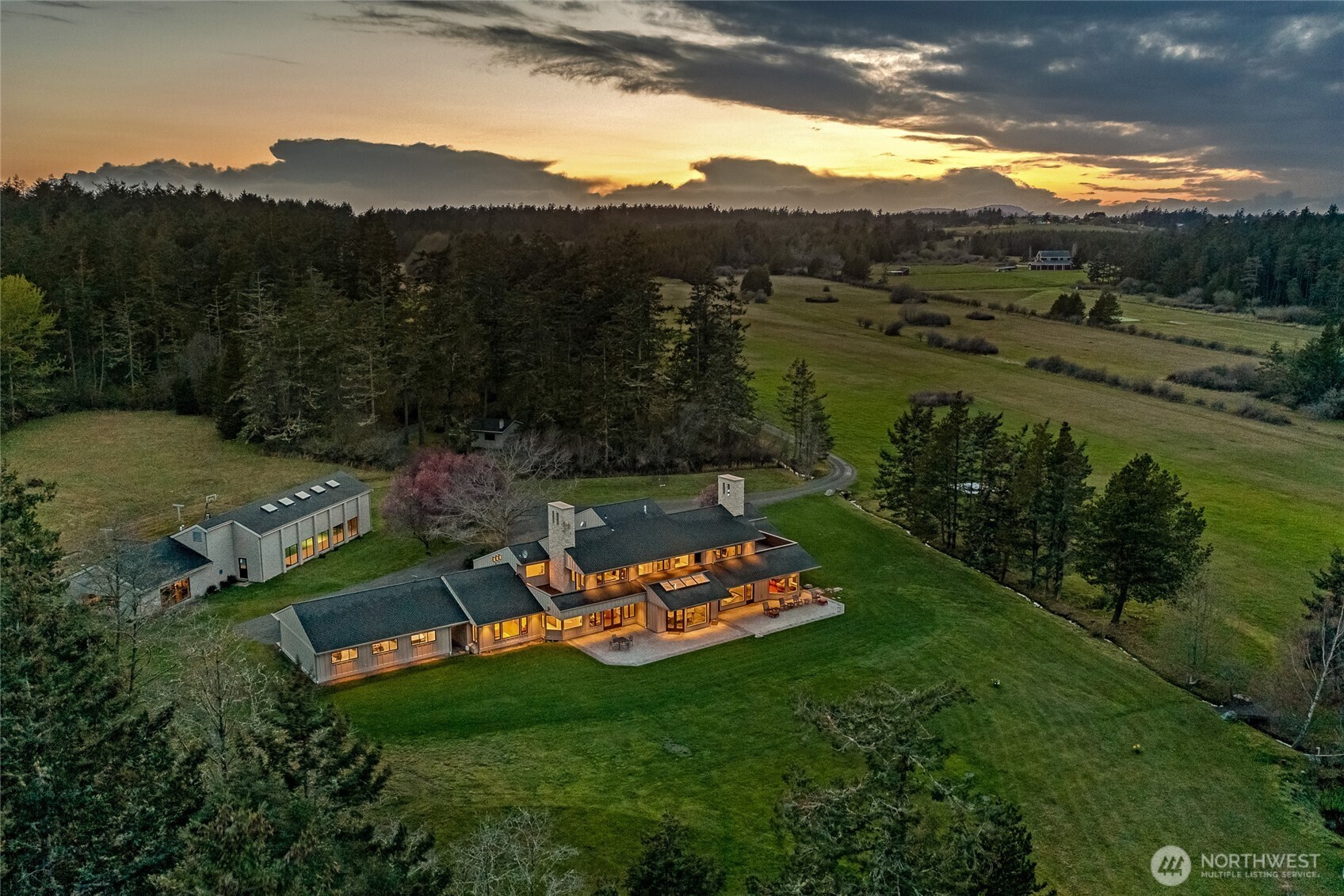 Experience the pinnacle of luxury island living with end-of-road privacy on 63± acres across and 515± feet of coveted low-bank waterfront. Panoramic views sweep over the San Juan Channel to Mount Baker and the North Cascades, offering a breathtaking natural backdrop year-round. The 8,674± sf two-level residence presents 6 bedrooms and 6 baths, thoughtfully designed with refined finishes, rich textures, and seamless indoor-outdoor flow for elevated entertaining and serene everyday living. Expansive terraces overlook orchards, gardens, and tranquil pond, creating a private retreat of rare beauty. Premier amenities include indoor pool, private gym, multiple garages, a historic barn, and a FAA-certified 2,400± ft airstrip with helipad - providing exceptional convenience and exclusivity. A distinguished legacy estate - commanding in presence, yet warmly inviting.