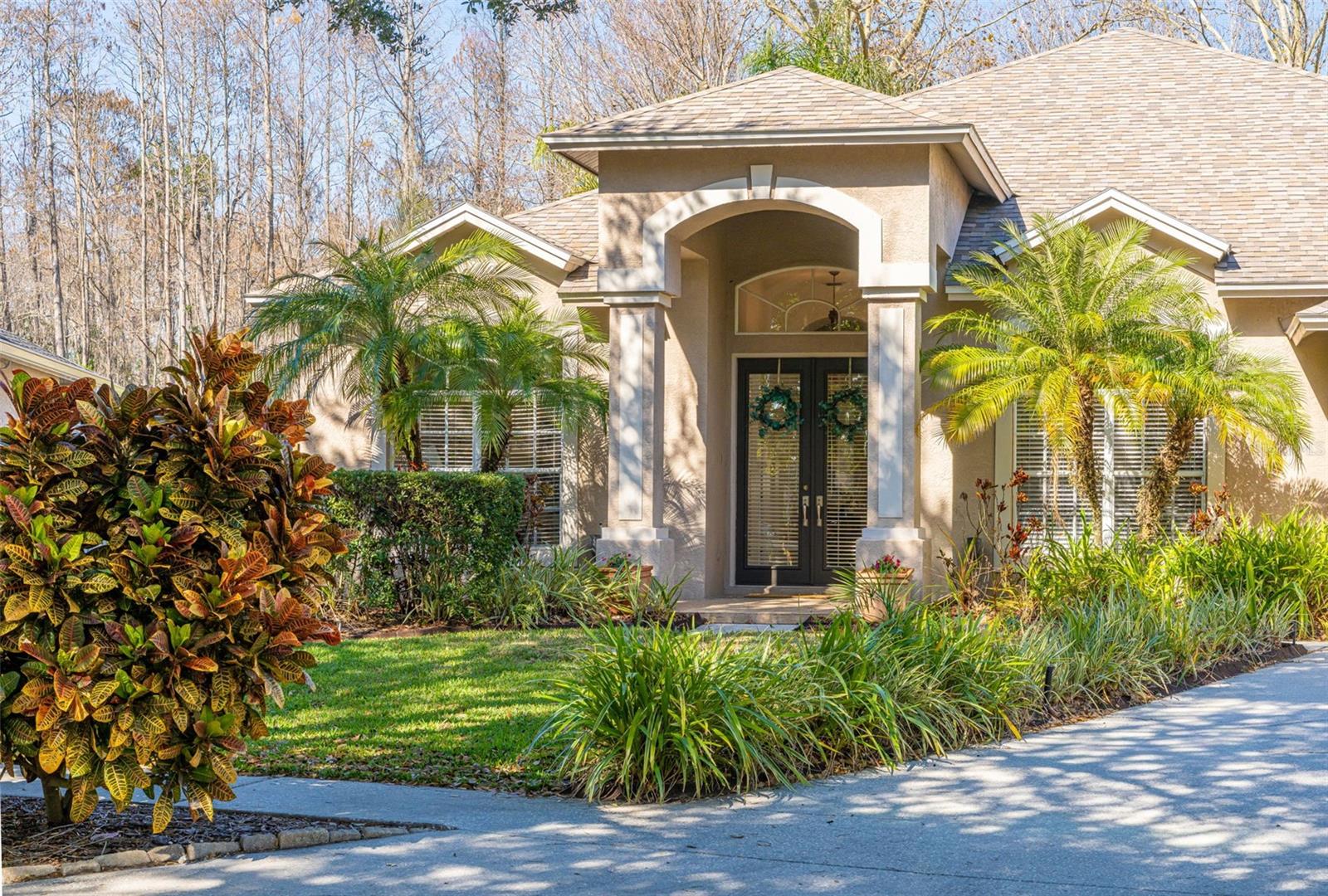 Welcome to your private retreat in the highly desirable Villarosa community! An exceptional home with 4-bedroom, 3-bathroom residence plus office, offering 2,853 sq ft of spacious living on an oversized private conservation lot. This thoughtfully designed floor plan features open-concept living and is perfect for entertaining. Enter through double doors into an expansive foyer, with a private office featuring French doors and a formal dining area just across the hall. The chef’s kitchen includes a center island, dinette space, oak cabinetry, granite countertops, stainless steel appliances, walk-in pantry, and breakfast bar overlooking the large great room. The great room is a showstopper with a built-in entertainment center, oversized movie theater screen, and gas fireplace—perfect for movie nights or game day. The primary suite offers added privacy with French door entry, two walk-in closets, and a spa-like bath with garden tub, separate shower, and dual sink vanity. Two additional bedrooms share a guest bath, each with walk-in closets. A fourth bedroom functions like a second primary suite, ideal for guests, in-laws, or older teenagers, featuring a large walk-in closet, ensuite bath, and private lanai access. Enjoy Florida living at its best with triple stack sliders opening to the covered lanai, screened pool, and outdoor kitchen—perfect for hosting gatherings. The fully fenced backyard offers even more with a firepit seating area and a putting green with sand trap. Additional highlights include an oversized driveway, 3-car garage with mini split A/C and EV charging station, and a newer roof (2020). Natural gas is available in the community. Located in desirable Villarosa with convenient access to the Suncoast Parkway, Tampa International Airport, International Plaza, downtown Tampa, St. Petersburg, major sports venues, and Gulf Coast beaches. Zoned for highly rated public schools and close to premier golf at Cheval Golf & Country Club and TPC Tampa Bay. Schedule your private showing today!