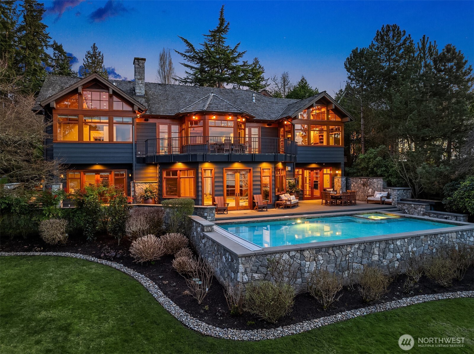 Experience waterfront luxury at its finest on Mercer Island’s coveted North-end. Rare & unparalleled lifestyle: 85’ of prime lakefront, rebuilt deepwater dock for ~100’ yacht & boat house. Floor-to-ceiling windows frame panoramic lake & city skyline views from soaring great room. Timeless PNW sophistication & meticulous craftsmanship: artisan wood, iron & stone finishes. Custom-built for both intimate living & grand entertaining w/ stunning chef’s kitchen & main floor owners’ suite. Expansive deck overlooks resort-style pool/spa & firepit at the water’s edge. Lower-level features huge office, 2nd kitchen, rec room & seamless walk-out water access. Graceful, level entry w/ circular drive, abundant parking, 3 car garage + ADU. One of a kind!