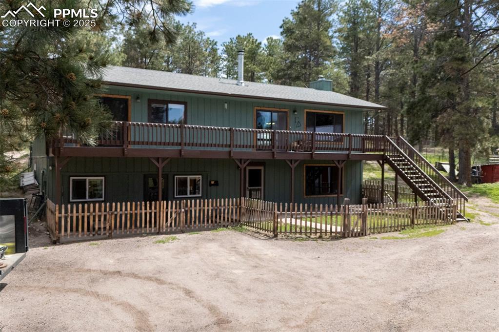 One-of-a-Kind 5+ Acre Farmhouse – No HOA, Guest Suite/apartment, 2 Barns, Large Garage/Workshop, Greenhouse & Shooting Range! This rare home is perfect for farm enthusiasts, horse lovers, or those seeking a self-sufficient lifestyle. Situated in the award-winning D38 school district, this property features over 5 acres of fully fenced, usable land & a wide range of amenities. The attached garage has been converted into a beautiful 600 sq ft apartment—ideal for guests, rental income, or multigenerational living which includes an additional 600 sqft w/ a full  bath, bedroom, double walk-in closets &  kitchen! A large metal two-car garage w/ an oversized bay door accommodates farm equipment with ease. Two additional barns on the property each have their own water & electrical supply for convenient animal care. Grow a garden underground in the 3-season greenhouse, complete w/ its own water source & temp gauge. A nearby root cellar provides excellent food storage. The land is fully fenced w/ multiple pastures & a round pen—ideal for equestrian use—and the gated entrance adds privacy & security. Inside the home, the main level includes a bedroom, ¾ bath, laundry room,&  a cozy family rm with it’s own pellet stove overlooking a park-like setting. This room can also function as a non-conforming 4th bedroom. Upstairs opens to a spacious family room with a wood-burning stove & seamless flow into the kitchen & dining area—perfect for entertaining. Enjoy indoor-outdoor living with direct access to both front & rear decks. The primary bedroom has private deck access, and the main bath includes an extra shower—perfect for dog washing. Many updated Renewal by Andersen windows & sliders ensure comfort & energy efficiency year-round. This property also features a private target shooting area, & a manual well pump. Enjoy country living with convenient access to the Air Force Academy, Colorado Springs, Monument, Castle Rock, and Denver areas!