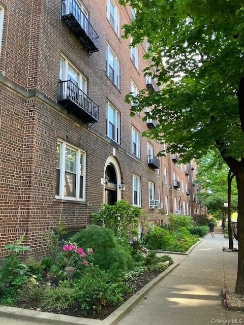 This beautifully restored Hampton Court home retains all the classic details that make prewar apartments so appealing.  The 1100 sq. ft. unit is located a half-level above the sidewalk for privacy and convenience. You enter a foyer, large enough for a desk and chair; to the right is the spacious living room, measuring 14’x17’.  From the living room a six-foot-wide opening, framed with crisp moldings, leads you to the 12’x17’ formal dining room. Both rooms have west-facing triple windows that measure roughly 6’ x 6’. The living room has a large new window AC unit (included) purchased in Jun 2026 and a ceiling fan with wood blades.The hall leads you to the kitchen with stone counters, tile floor and backsplash, and generous storage space. The built-in pantry and all the lower cabinets in the kitchen have pull out drawers. The gas double oven has a full-size oven below the stovetop and a smaller oven above. The refrigerator was purchased in July 2026. Beyond the kitchen are two bedrooms and full bath.  The larger bedroom has a large west-facing window, while the other has two windows that face Hampton Court’s verdant interior garden. The bedroom that faces the garden comes with 2” premium wood blinds, an Elfa storage system in the closet, and an AC window unit. Both bedrooms have ceiling fans. The two hall closets also have the Elfa metal storage system.Fully renovated, the bathroom has subway tile walls with mosaic slate tile floors, and solid slate trim around the windows, the tub front, and above the tiles. The bathroom window also features a marble jamb detail. Fixtures include a Duravit sink, Toto toilet, and a deep Toto tub. The tub is a large soaking tub approximately 15” deep. The custom shower doors feature the ultra-clear Starphire glass for high clarity.The apartment’s prewar details include nine-foot ceilings, plaster walls, wood moldings and picture rails, coved ceilings in the living and dining rooms, oak strip floors, and gorgeous stripped and refinished walnut doors throughout.