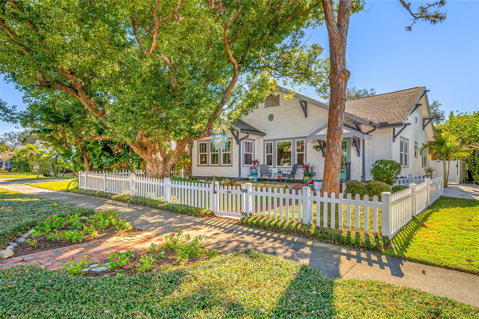 LOCATION, LOCATION, LOCATION! There is a specific kind of magic that exists on the border of North Clearwater and Dunedin. As featured in the Tampa Bay magazine, this is a neighborhood where the trees themselves tell stories. You'll see tree lined streets with full-sized chandeliers of mermaids, glowing jellyfish, flamingos and this home's own custom Chihuly-inspired bubble fixture that shines bright, a gift of "literal light" created by neighbors to lift the spirit. While many historic homes require a compromise between character and convenience, this charming bungalow with 3 bedrooms, 2 baths, and 1,658-sq ft, has been lovingly brought into the modern era. The goal of the current owner was simple, preserve the soul of 1925 while bringing the home up to todays standards. In 2006, the plumbing was updated and in 2008 the electrical was updated. The journey began for this owner in 2019, with over $90,000 in recent upgrades, starting with a high-efficiency tankless water heater was installed, and a dedicated gas line. In 2020, the focus shifted to the exterior, with Hurricane-grade windows installed on all but the unexposed east side of the house and a gutter system around the home. The owner also added a custom-designed 10x10 Tuff-Shed, providing ample space for hobbies, gardening tools, etc. The year 2022 brought one of the most significant upgrades any homeowner could desire: a brand-new roof, and in 2023 the HVAC was replaced. The primary bathroom was completely renovated in 2023 with subway tile, high-end fixtures, and a free standing soaking tub, bridging the gap between the home's vintage roots and contemporary luxury. In 2024, the final touches were applied with interior & exterior painting. All in all, this home can be described as "bungalow chic" with hardwood flooring throughout, a cozy fireplace in the living room, along with a sunroom,  dining room, and a functional kitchen with quartz counters, and stainless steel appliances. While the front porch is for connecting with the neighborhood, the backyard is for escaping the world. The current owners have transformed this space into a true oasis. In 2020, a new back brick patio was added, creating a sophisticated transition from the back door to the gardens. Here, you will find a fully fenced yard, with an outdoor screened-in gazebo and a dedicated BBQ area, perfect for entertaining. The landscaping has been lovingly cared for to create layers of privacy and color. There is an accessible gate which provides the perfect parking spot for a golf cart—the preferred mode of transportation in this golf-cart-friendly community. From here, you are only a block away from the Pinellas Trail, the Neighborhood Park, and the scenic beauty of waterfront Edgewater Drive. You are minutes away from the vibrant energy of Downtown Dunedin with its boutique shops, award-winning breweries, restaurants, and art galleries. With $90,000 in recent upgrades, the heavy lifting has been done. The roof is new, the air is cold, the windows are strong, and the spirit of 1925 is alive and well. This is your opportunity to own a piece of Clearwater history, wrapped in the comfort of modern luxury. As the teal and purple lights of the Chihuly fixture reflect off the iridescent glass and the evening breeze begins to kick up from the Intracoastal as you watch the sunset from your porch, you will realize that this isn't just a home, it is the beginning of your next chapter. NOT IN A FLOOD ZONE! (X500) NO FLOODING